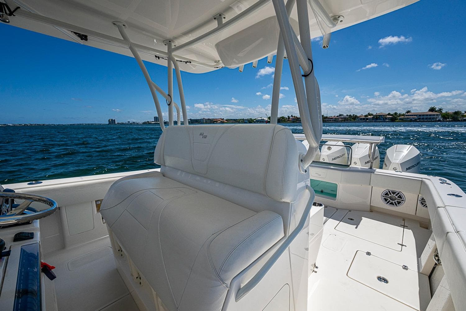 2023 SeaVee 390B boat interior with white seating, ocean view, and clear blue sky.