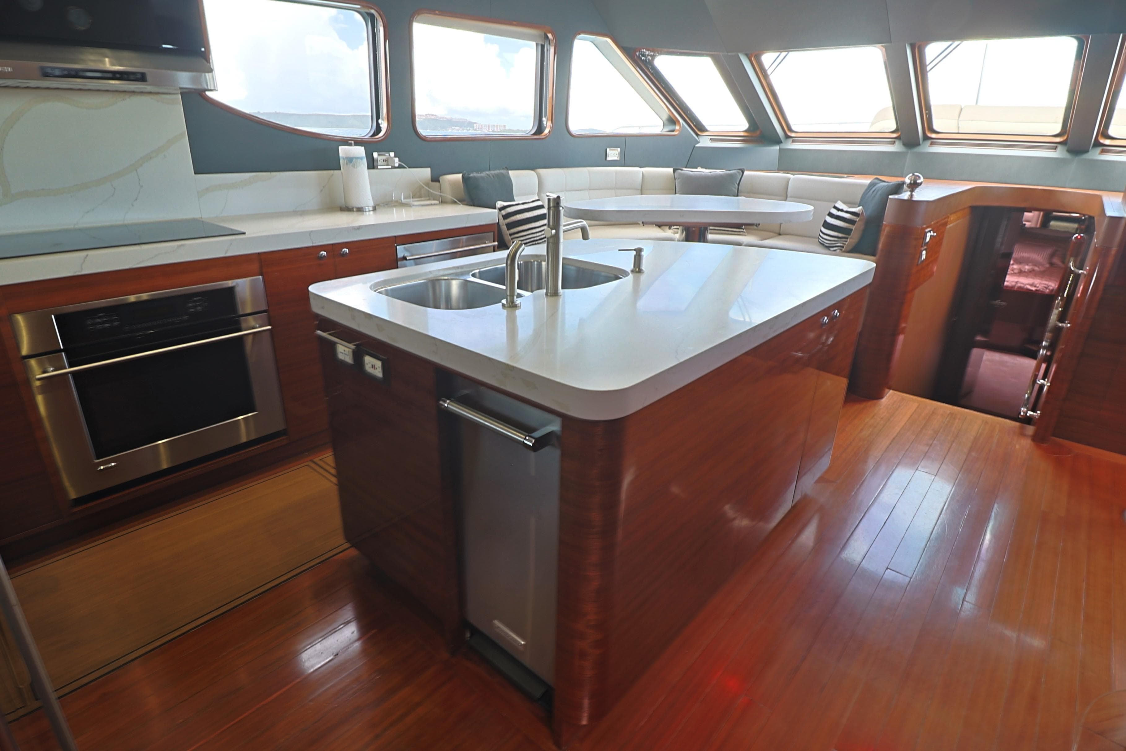 Luxurious Cheoy Lee Bravo 2013 yacht kitchen with modern appliances and sleek design.