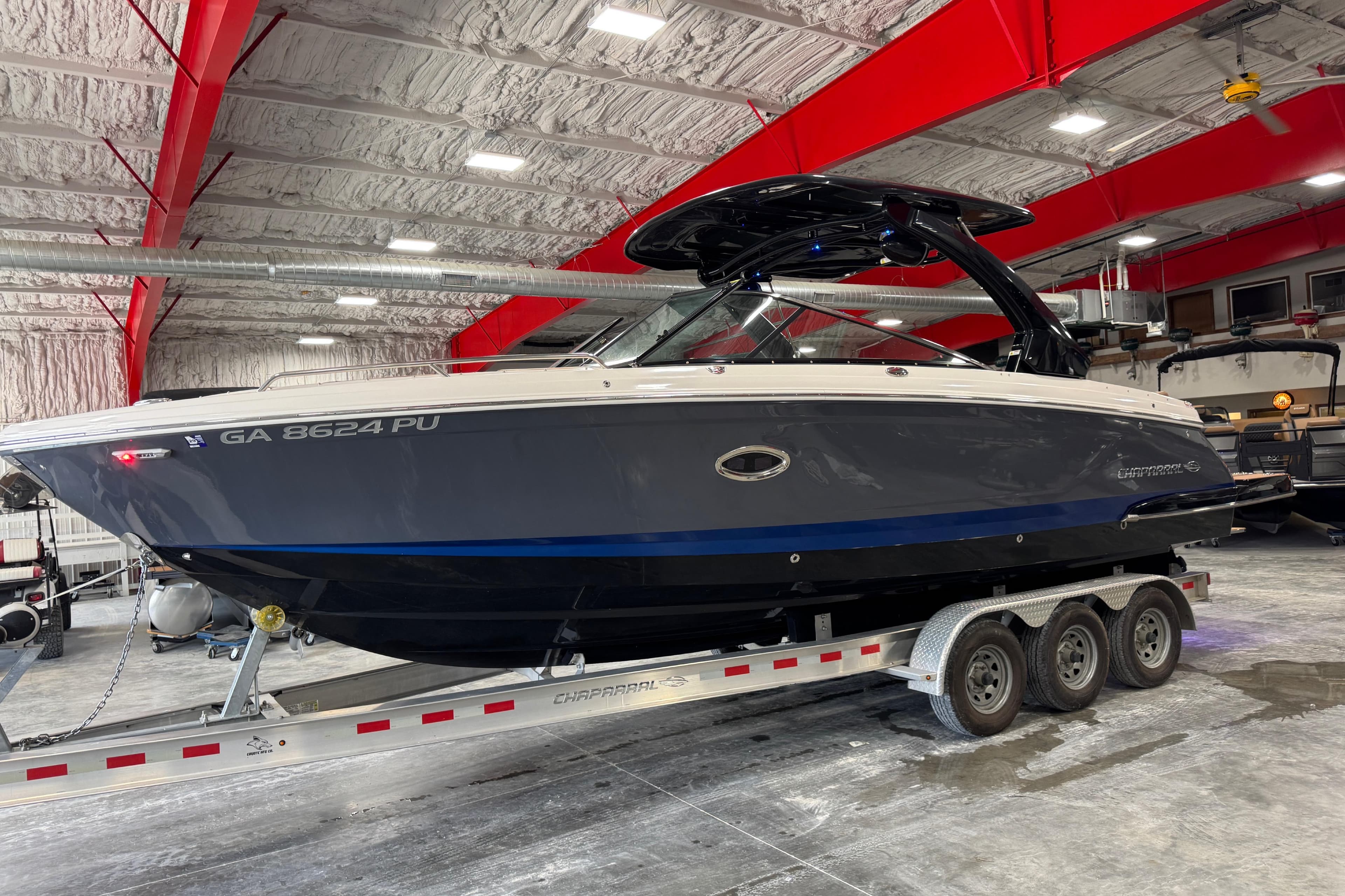 2023 Chaparral 307 SSX boat on trailer in indoor storage facility.