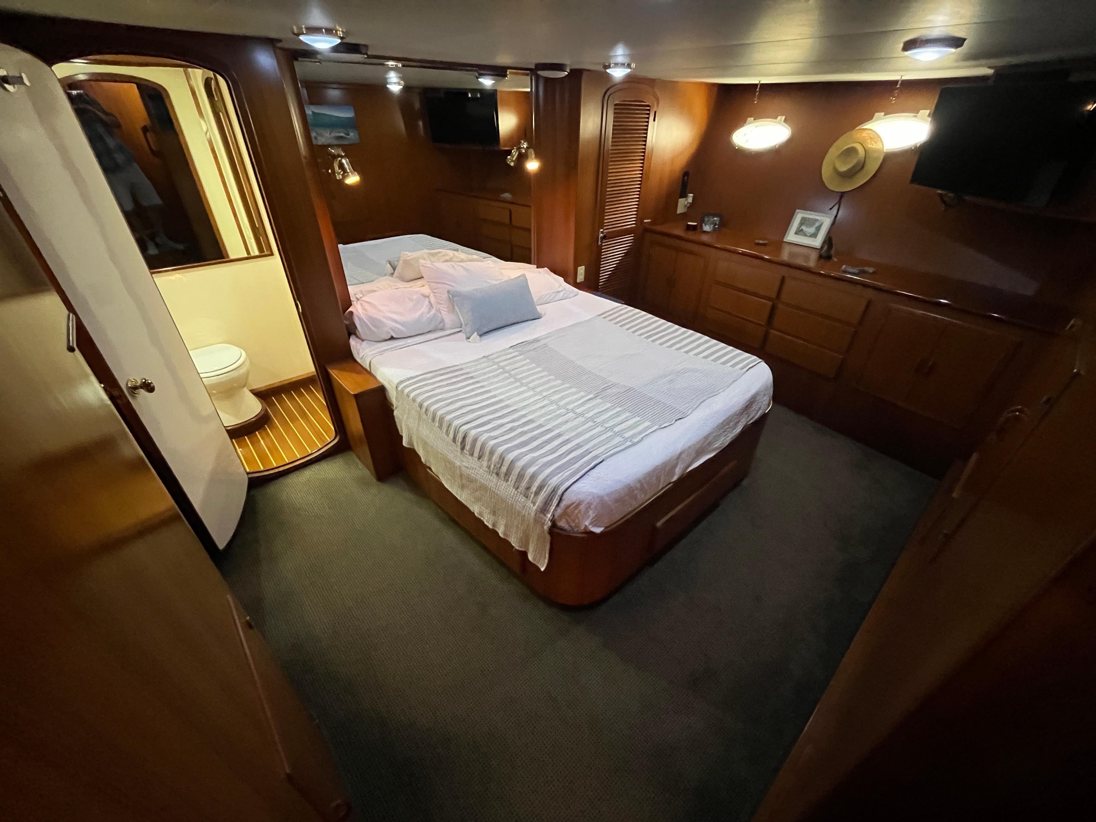 Luxurious bedroom interior of 1999 Mikelson Long-Range Luxury Sportfisher yacht.