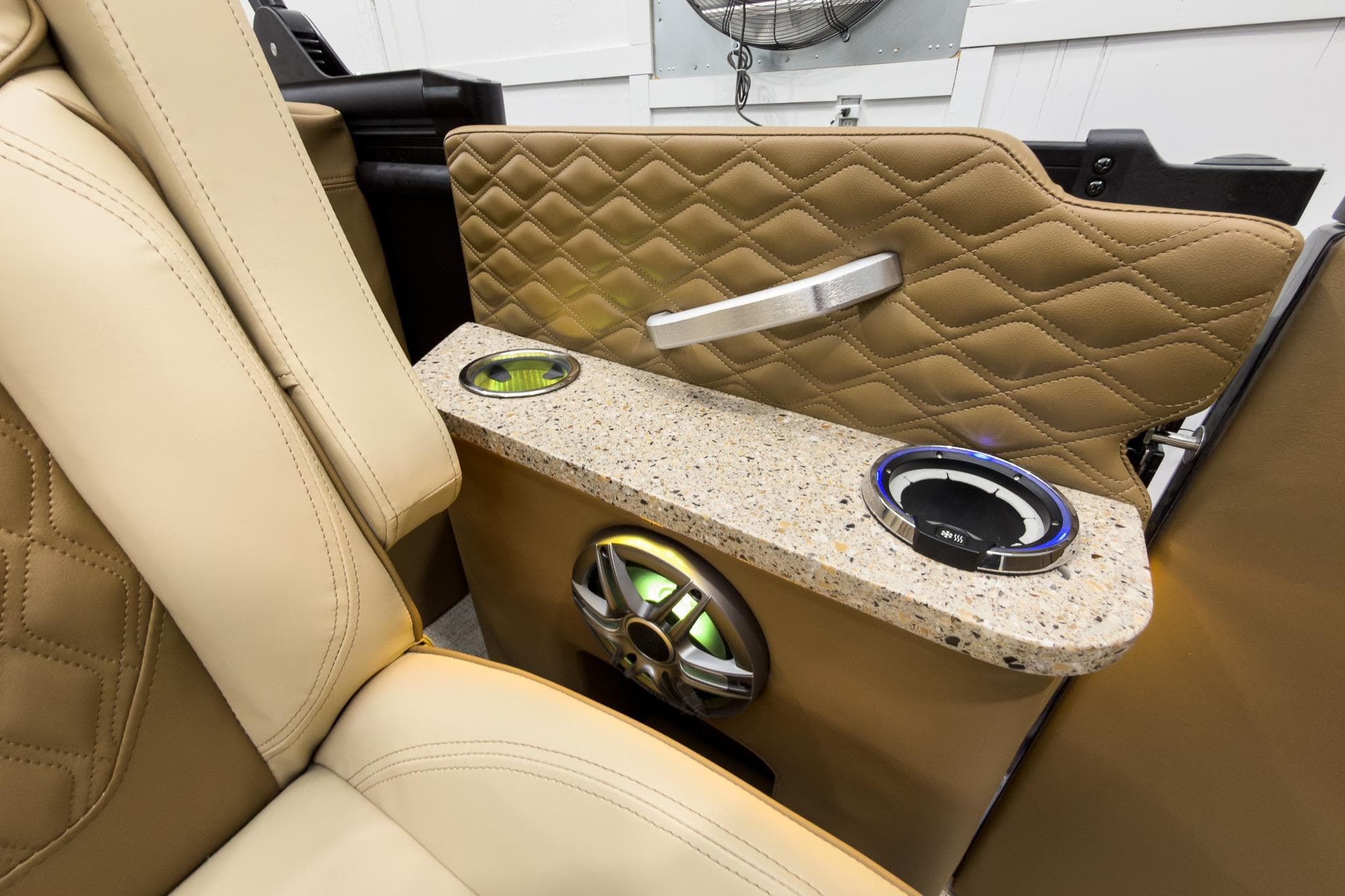 Luxurious interior of 2026 Godfrey Sanpan 23' Ultra Lounge Tritoon with cup holders and speaker.