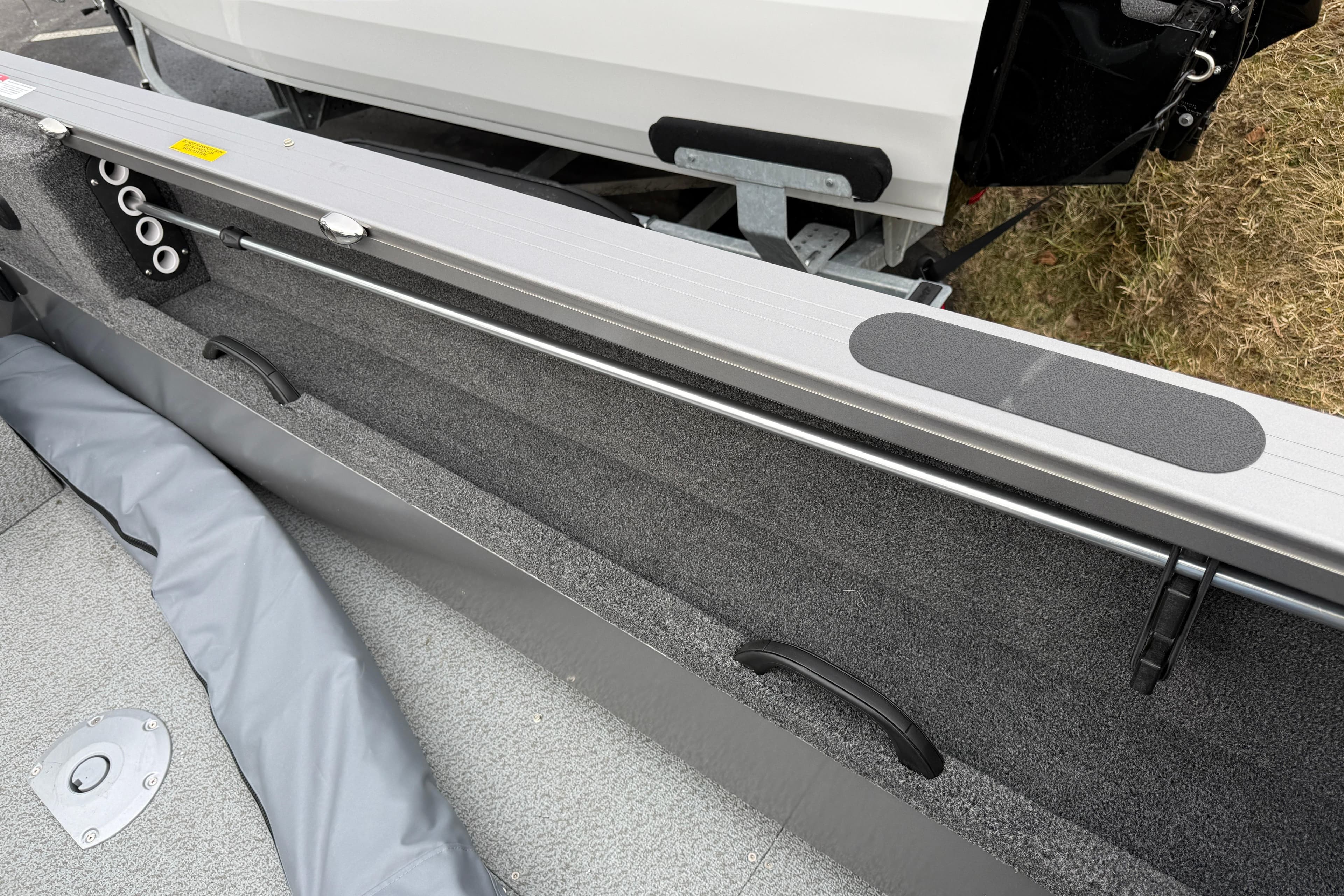 Interior view of 2026 Crestliner 1850 Commander boat, showcasing storage and rod holders.