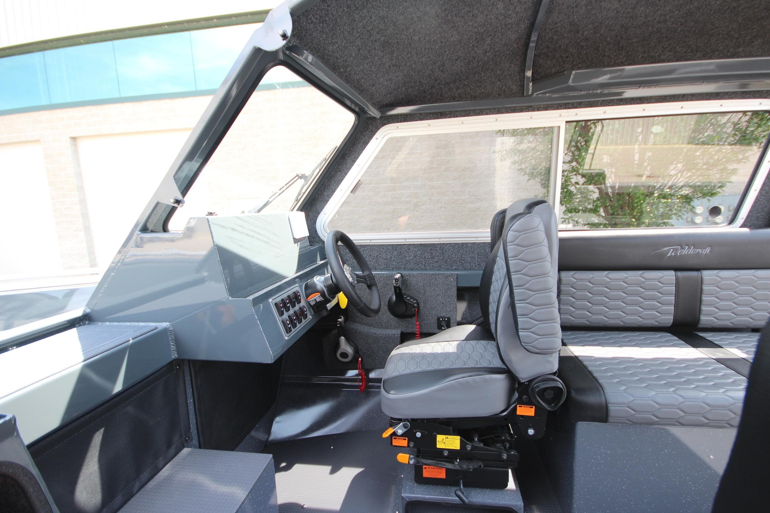 Interior of 2027 Weldcraft 240 Maverick DV boat with modern seating and controls.