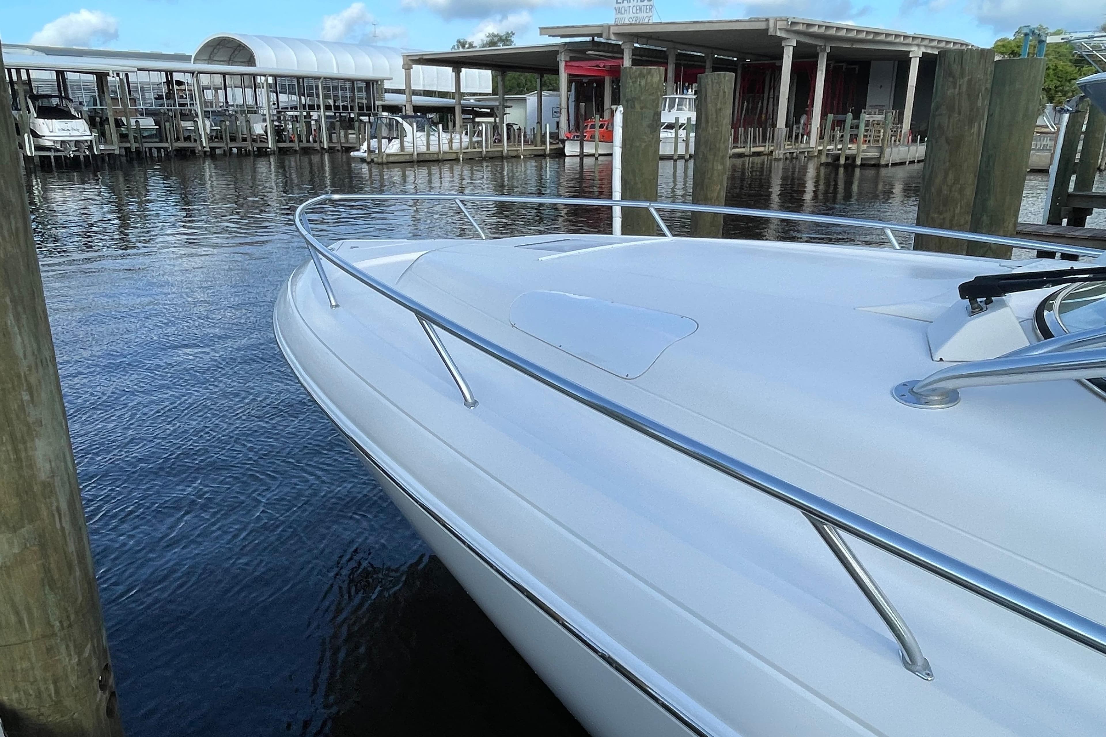 2009 Intrepid 430 Sport Yacht docked at marina, showcasing sleek design and polished railings.