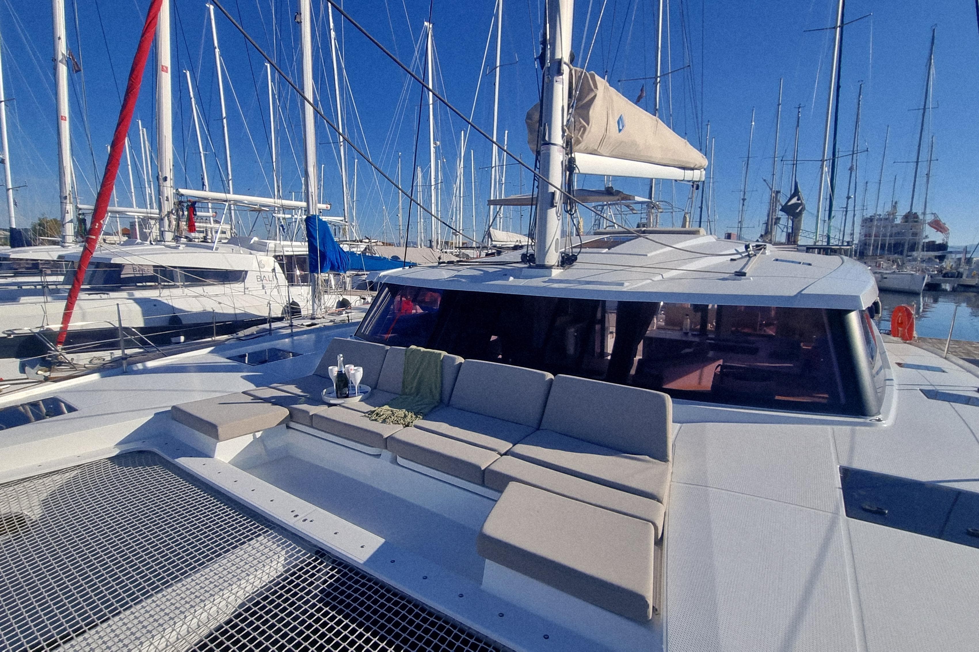 2024 Fountaine Pajot Astrea 42 Catamaran docked in a marina, showcasing spacious deck seating.