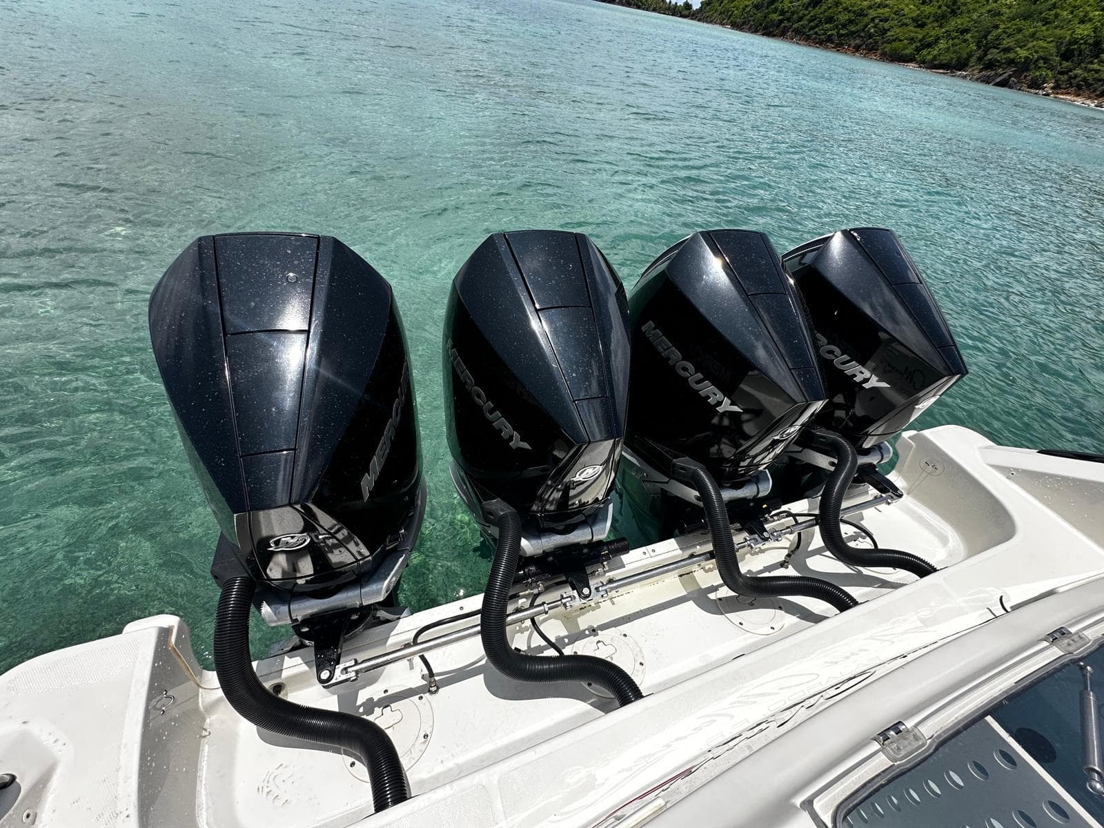 Four Mercury outboard engines on a 2020 Boston Whaler 380 Outrage in clear water.