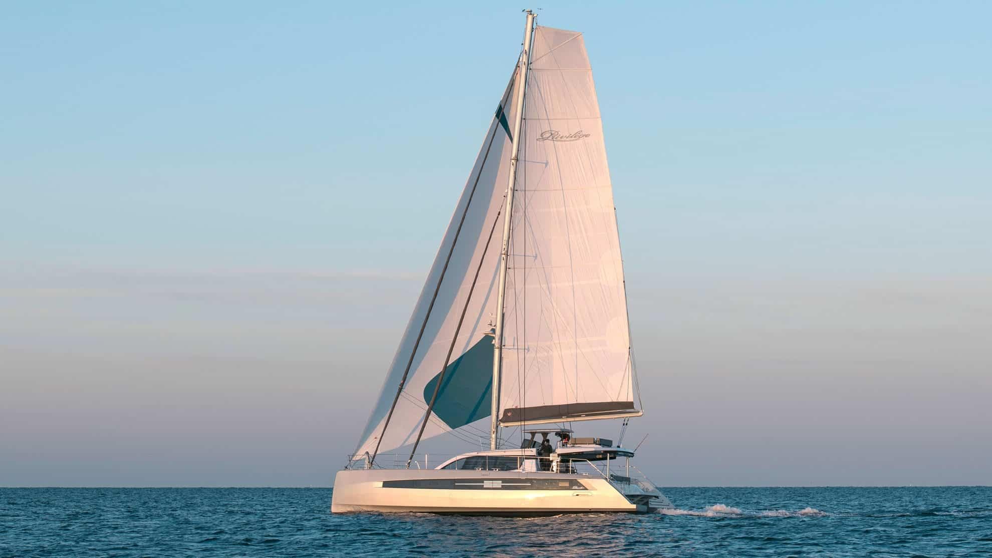 Luxury Privilege Signature 580 catamaran sailing on calm sea, 2025 model.