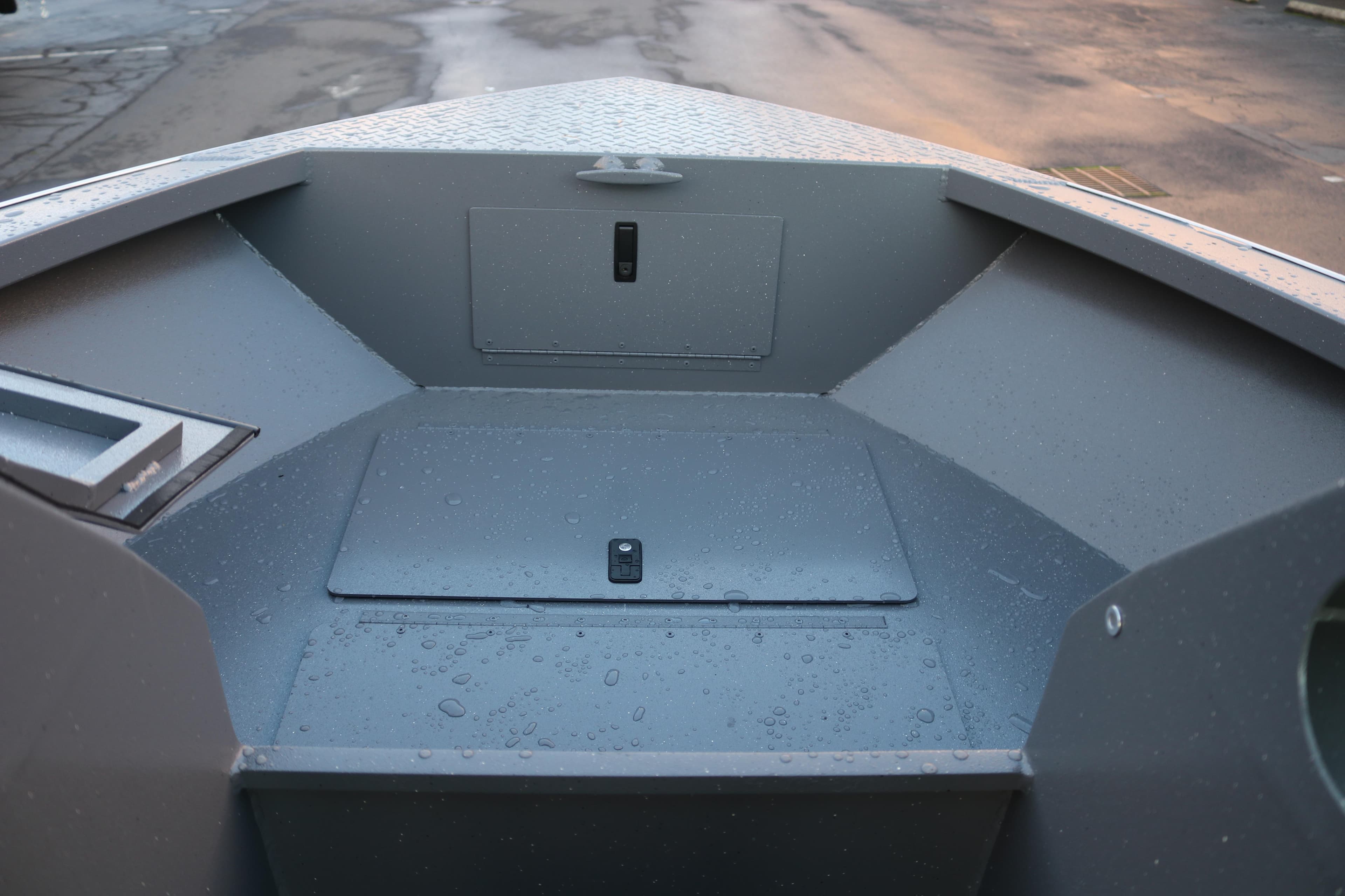 2026 Alumaweld Stryker 202 boat interior with storage compartments, wet from rain.