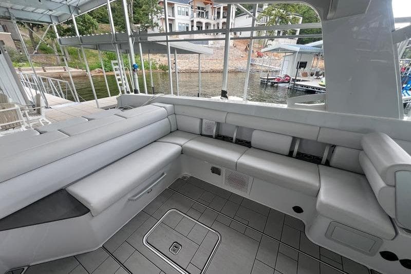 Luxurious seating area on 2023 Aviara 36 boat docked by the waterfront.