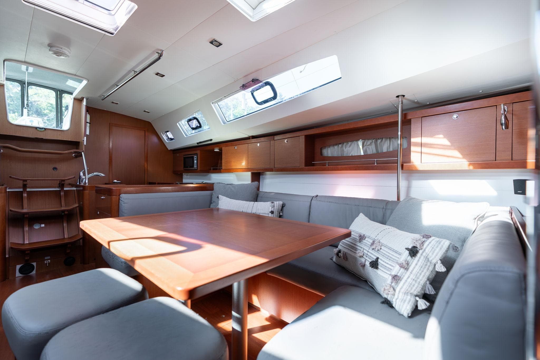 Luxurious interior of 2013 Beneteau Oceanis 50 yacht with modern seating and ample natural light.