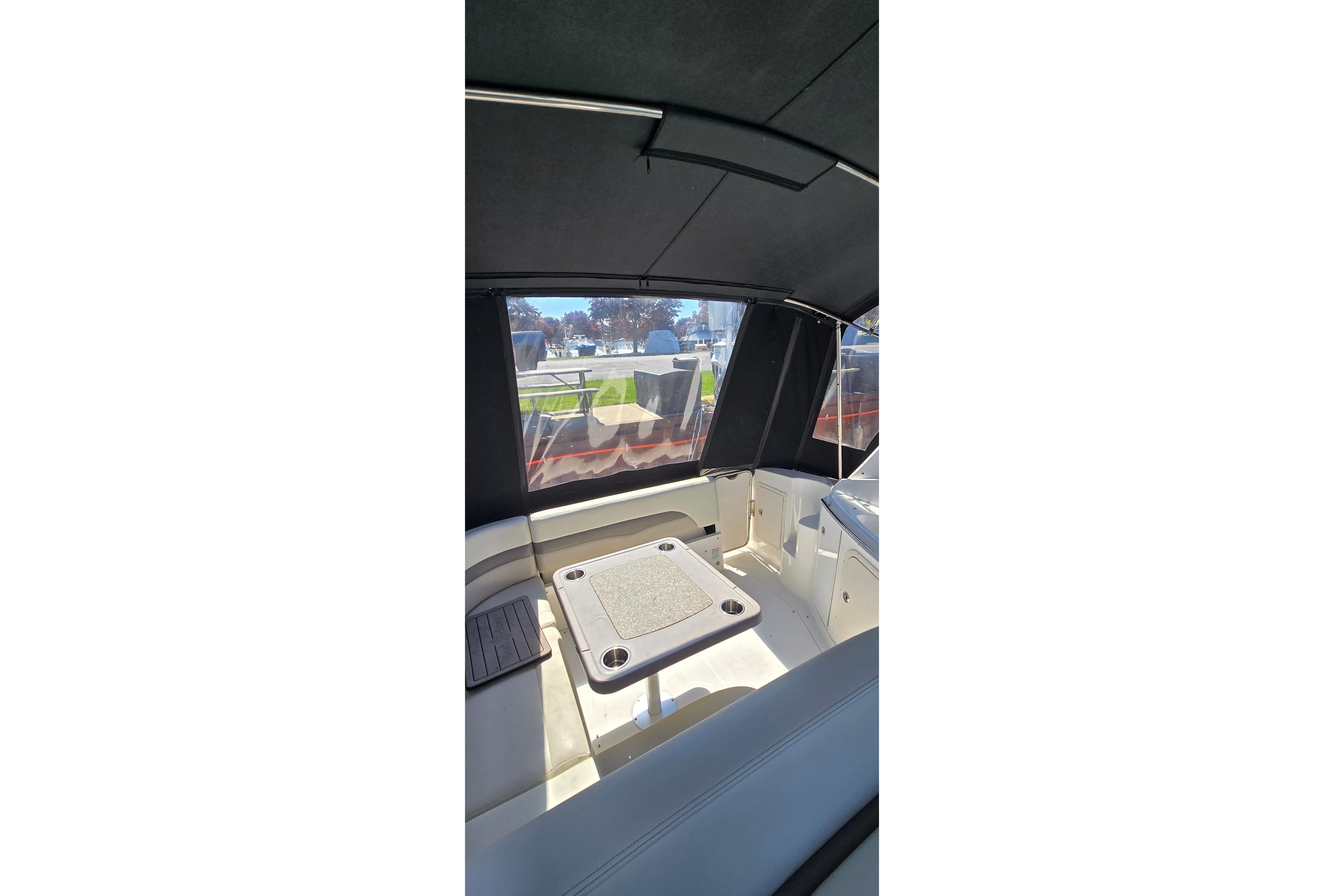 Interior view of 2009 Chaparral Signature 310 boat with seating and table.