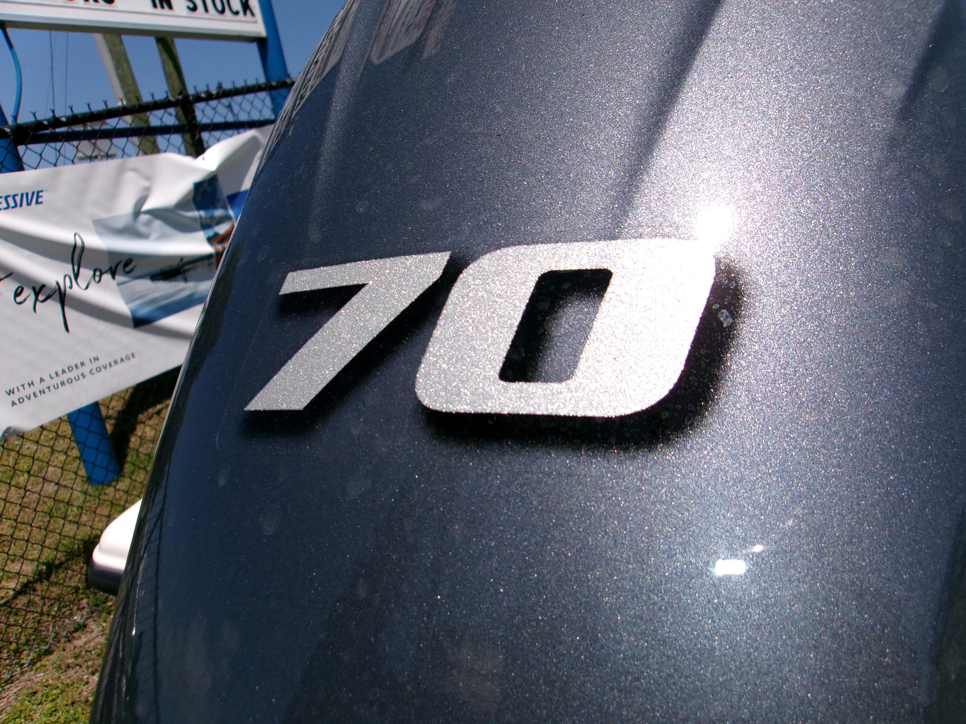 Close-up of '70' emblem on 2025 Key West 1720 boat, metallic finish.