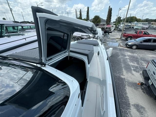 2024 BRABUS Shadow 1000 ST luxury boat with open cabin, docked in a marina.
