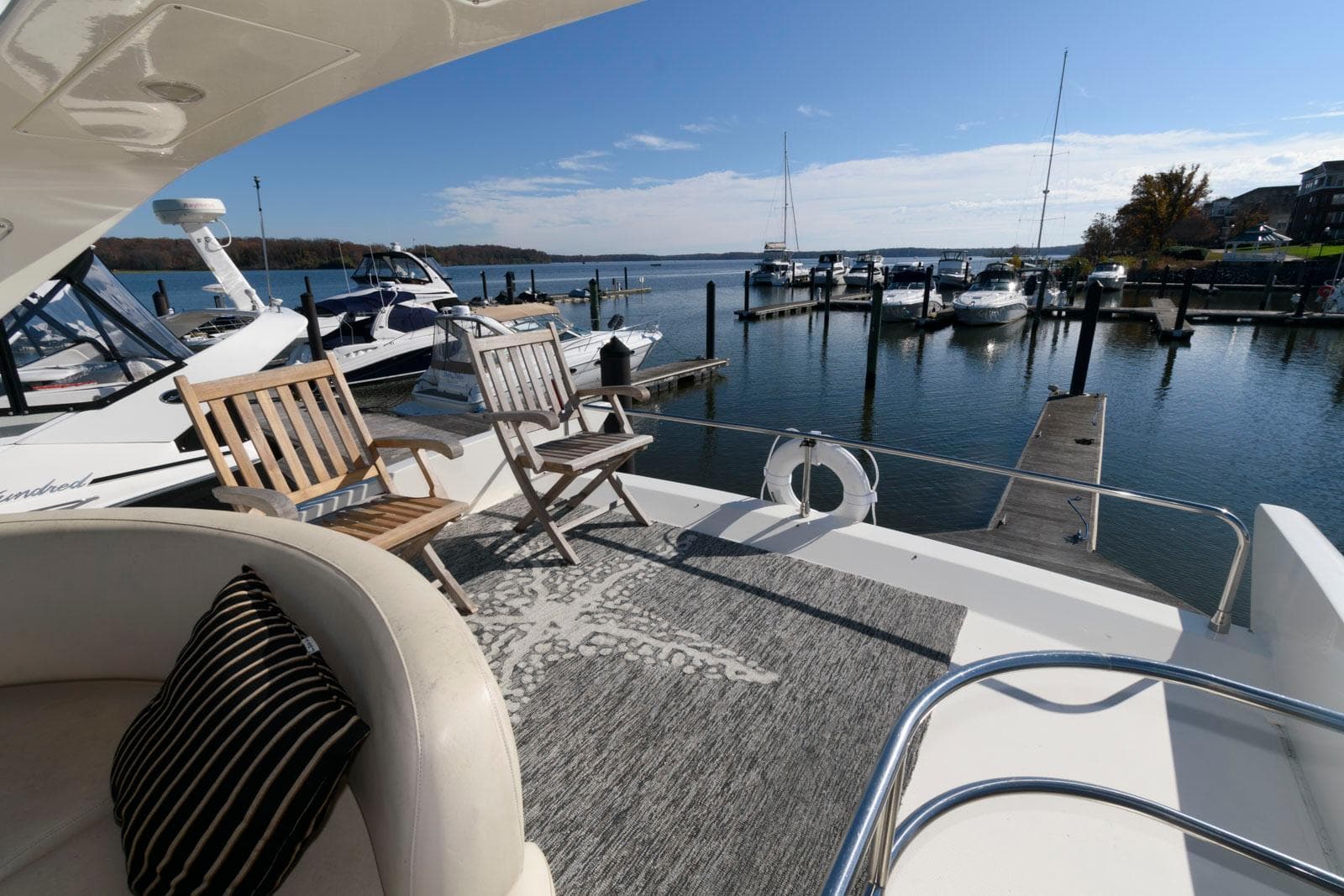 Azimut 50 Flybridge 2005 yacht deck with chairs overlooking marina.