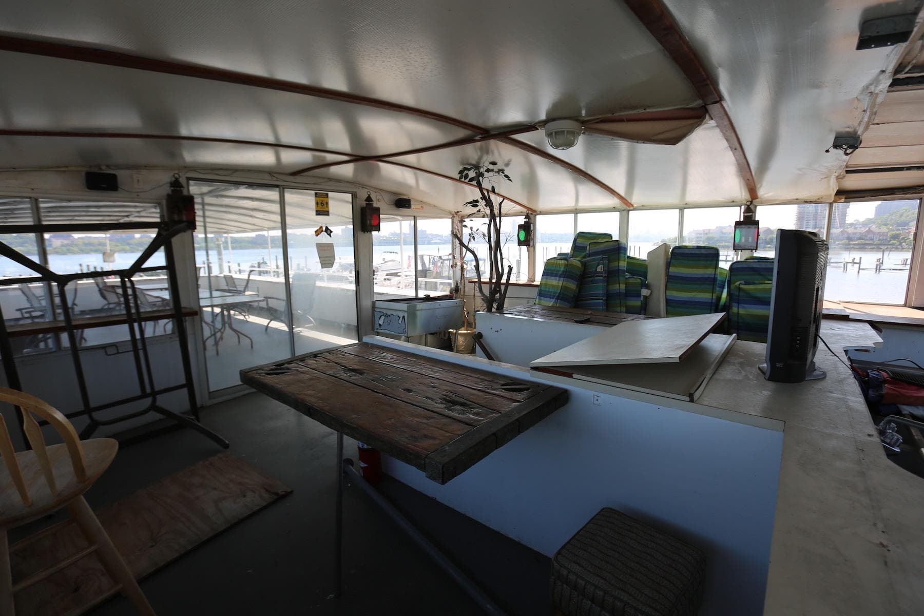 Interior of 1988 Winston Knauss 64 party boat with seating and wooden table.