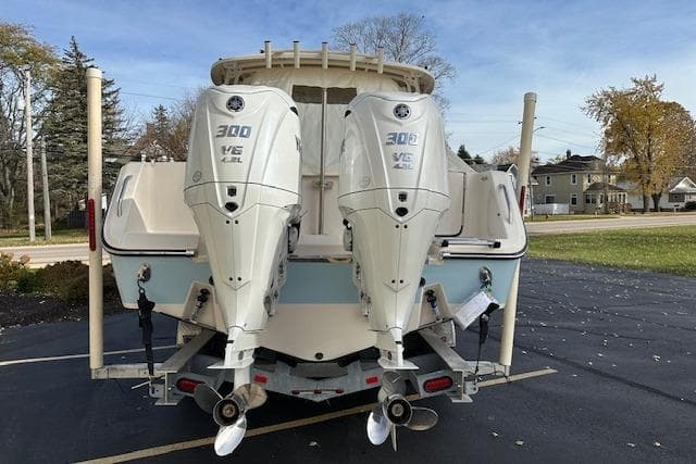 2024 Grady-White Freedom 307 boat with twin 300 V6 engines, parked outdoors.