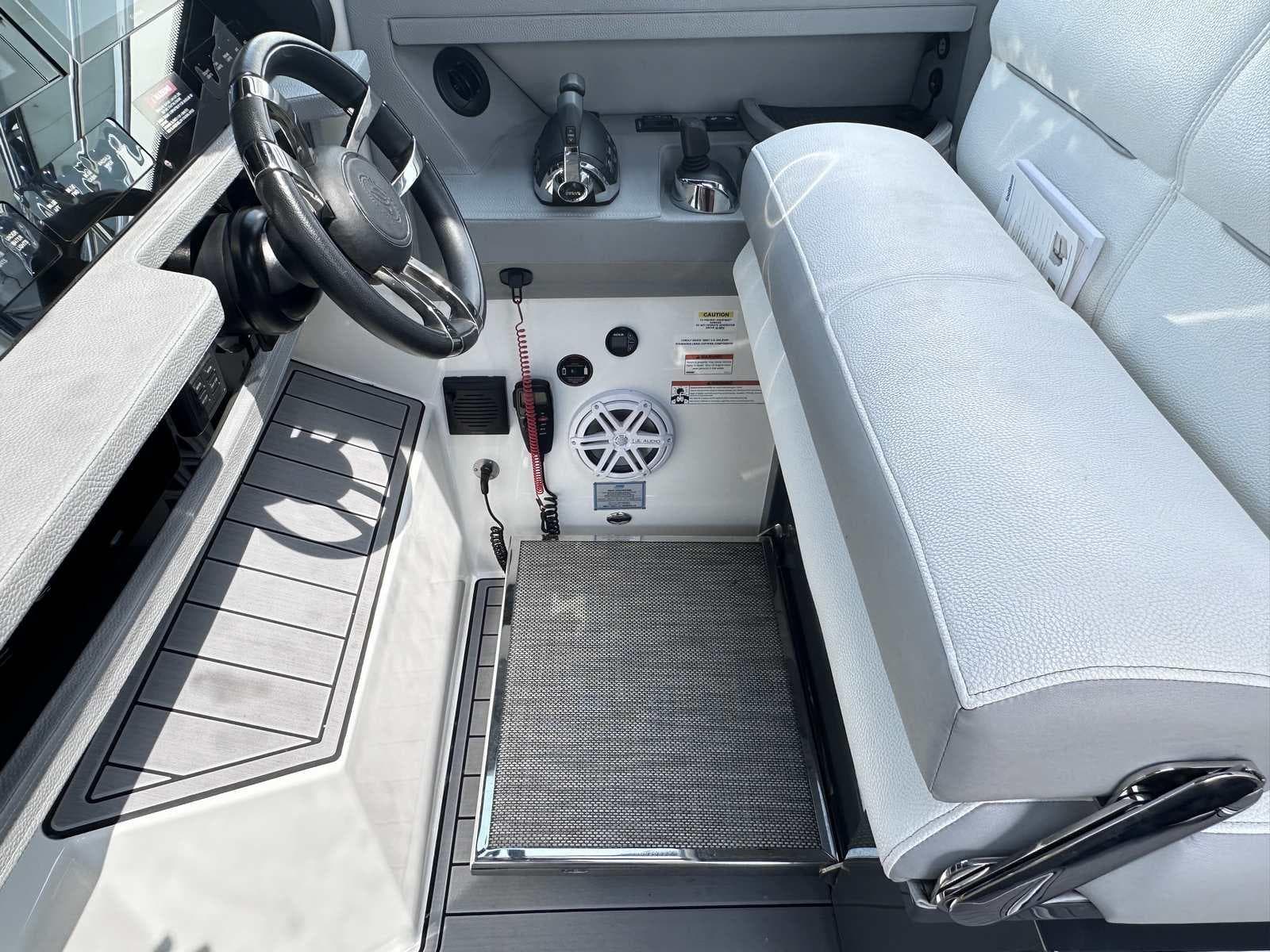 2019 Cobalt A36 boat cockpit with steering wheel, controls, and cushioned seating.
