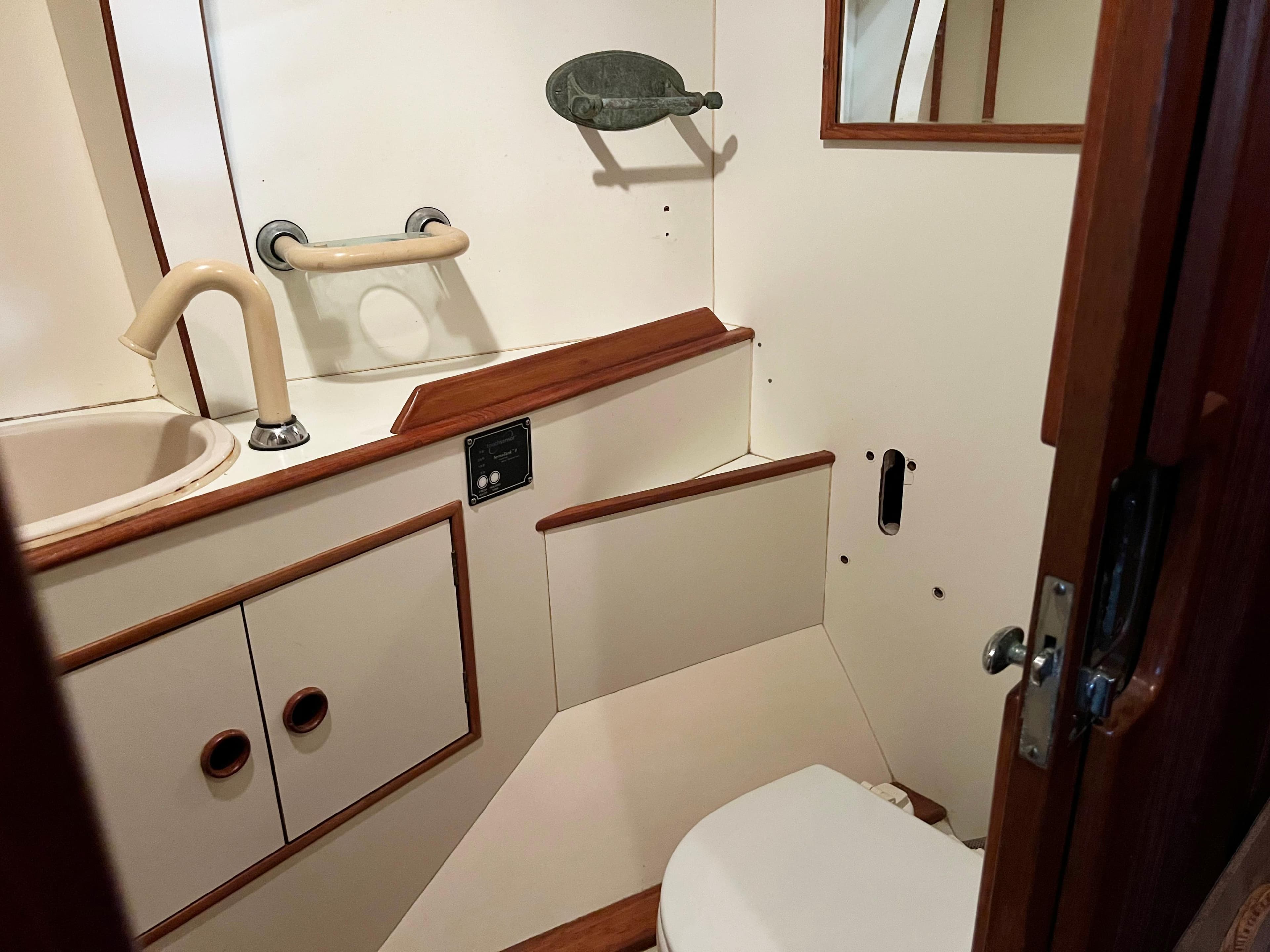 Interior of 1987 Oyster 46.5 yacht bathroom with sink and toilet.