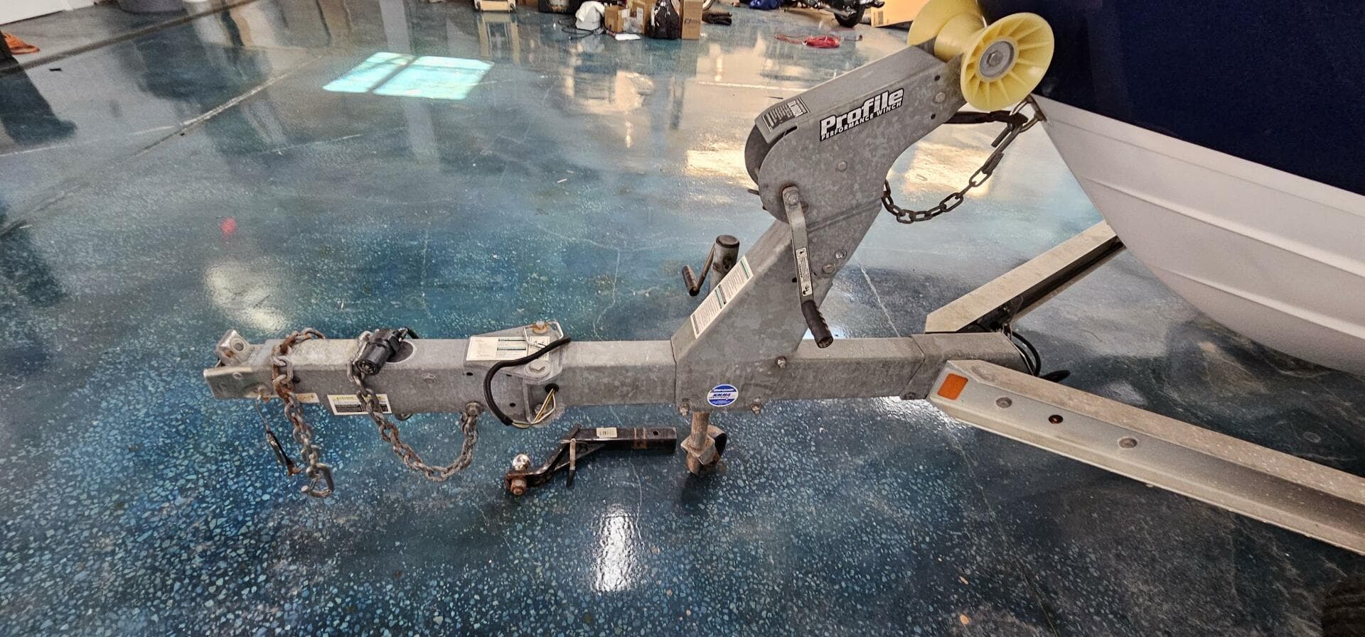 Trailer hitch of a 2018 Yamaha Boats 210 FSH Deluxe on a polished floor.
