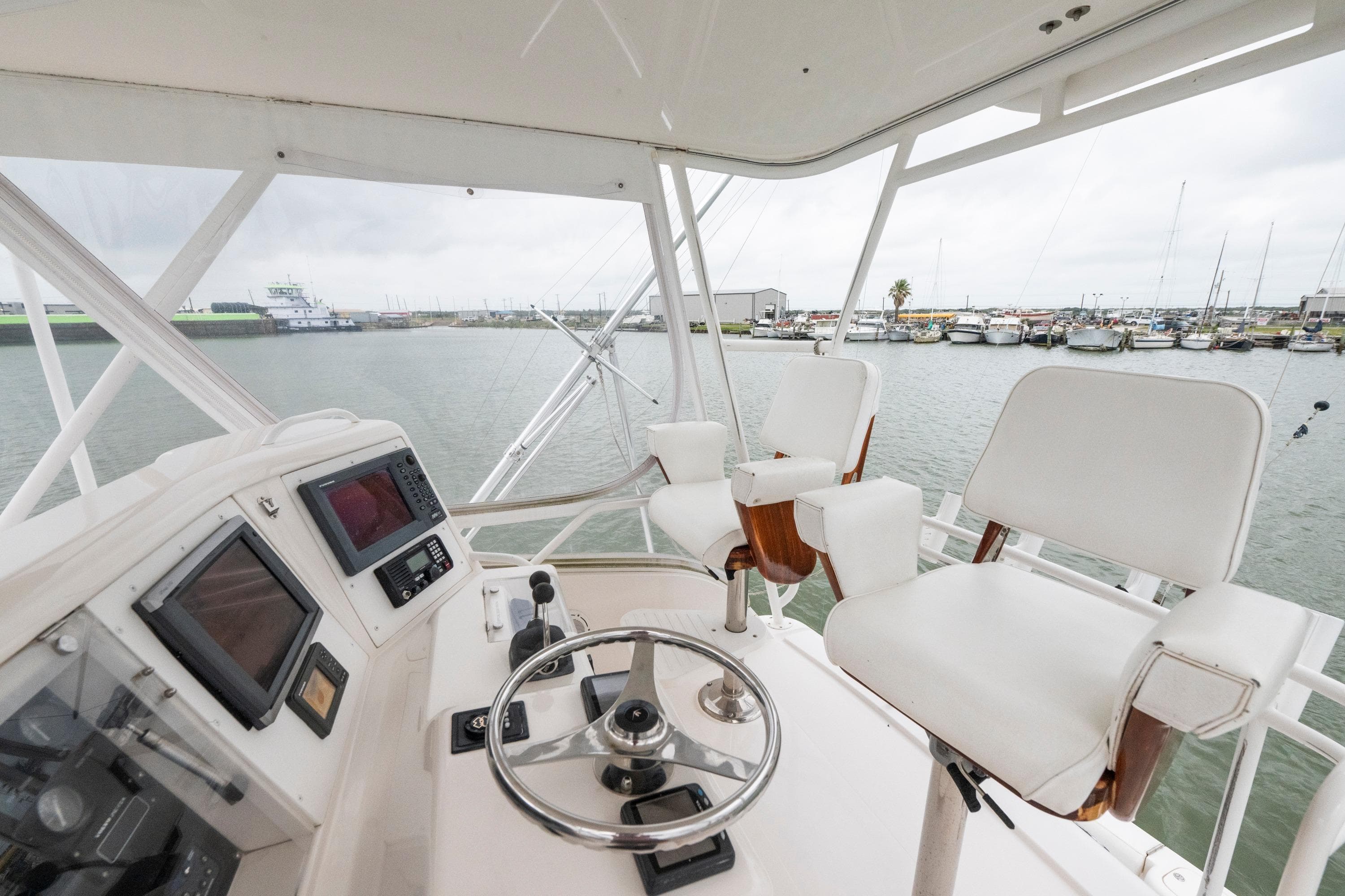 Helm of 2004 Bertram 390 Convertible yacht with steering wheel and navigation equipment.