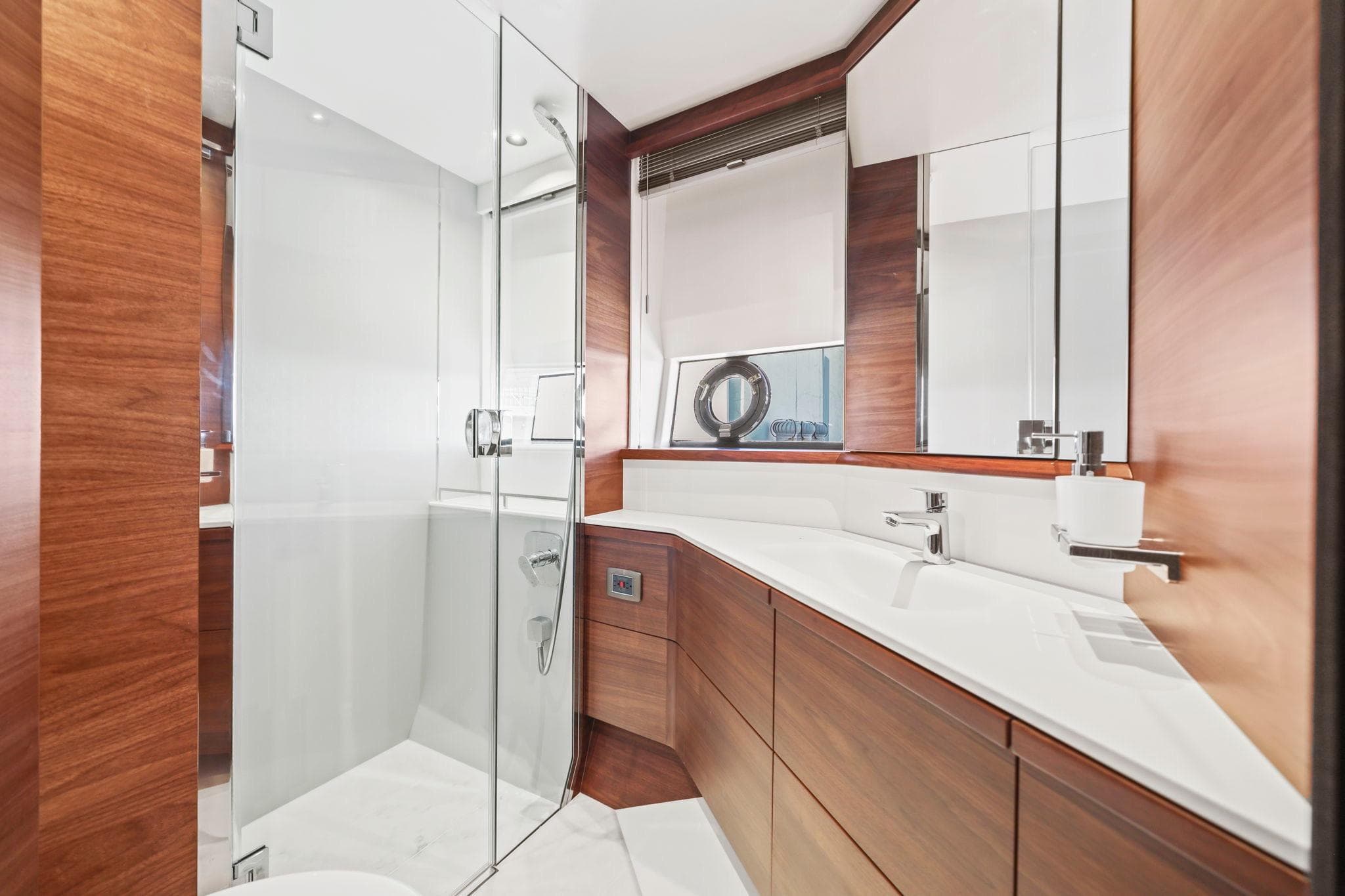 Luxurious bathroom in 2026 Princess F65 yacht with sleek wood finishes and modern fixtures.