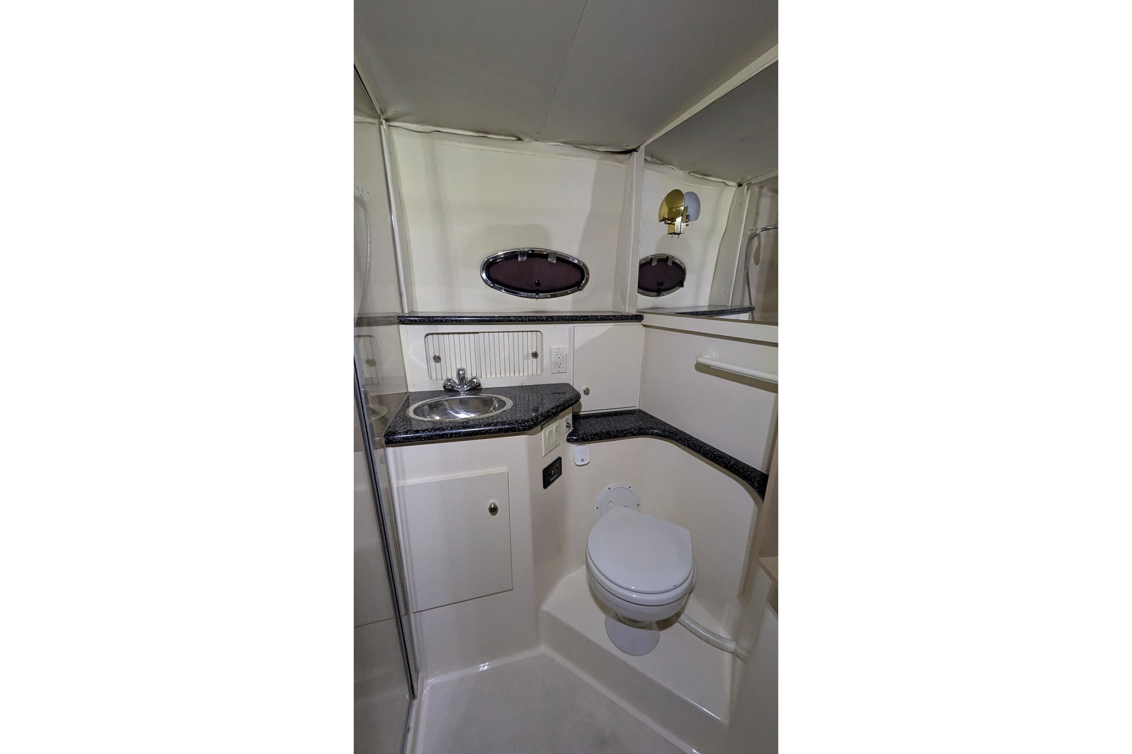 Bathroom interior of 2000 Carver 404 Cockpit Motor Yacht with sink and toilet.