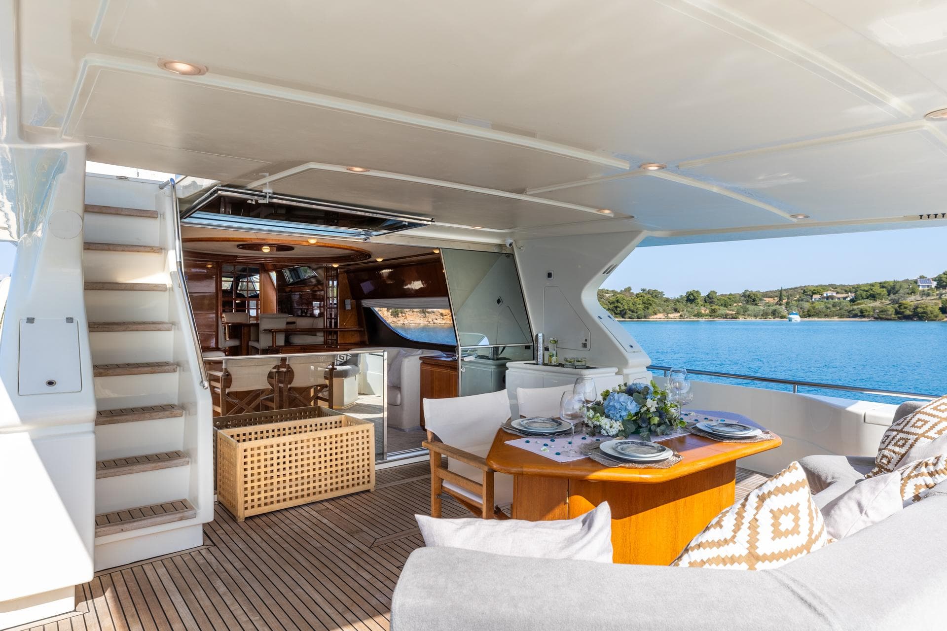 Luxurious 1999 Ferretti Yachts 80 interior with elegant dining area and scenic ocean view.