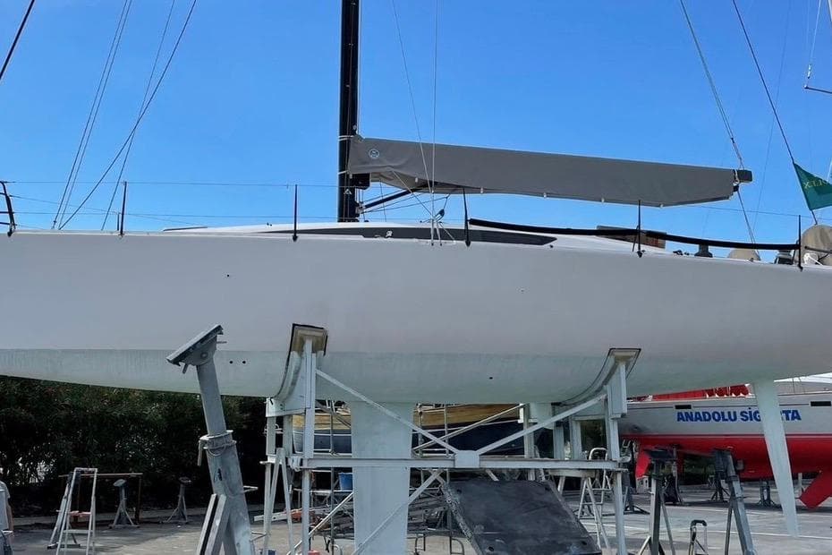 2015 Sydney 43 GTS sailboat on dry dock, showcasing sleek design and modern rigging.