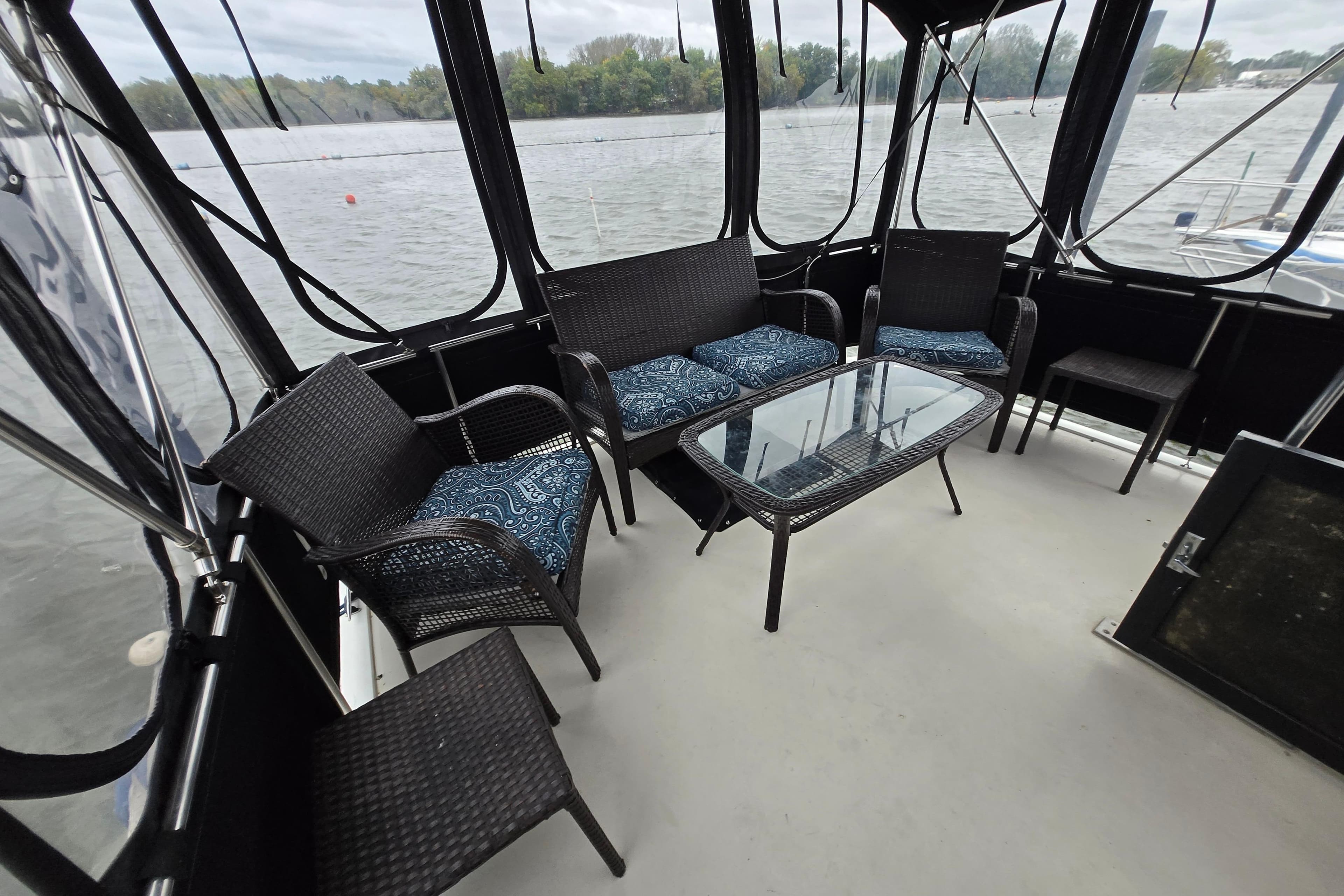 1988 Mainship 36 Double Cabin with wicker seating and glass table on deck.
