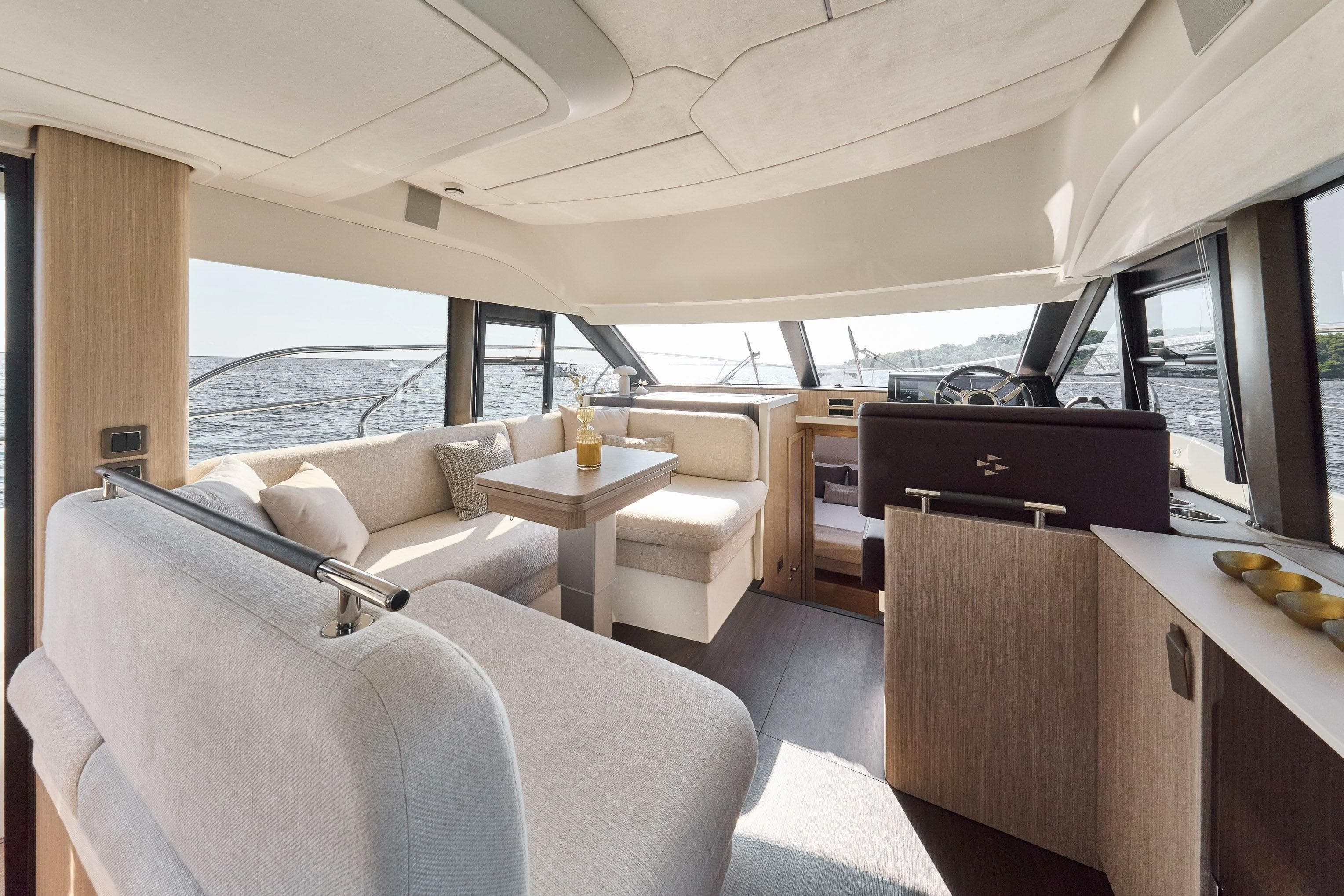 Luxurious interior of 2026 Prestige F4.3 yacht with elegant seating and panoramic windows.