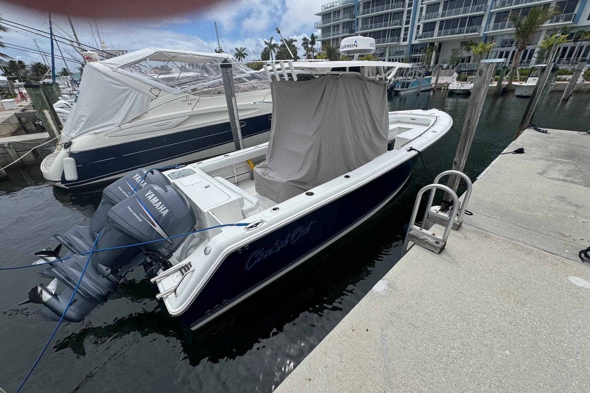 2011 Sea Hunt Gamefish 27 boat docked with Yamaha engines, marina background.