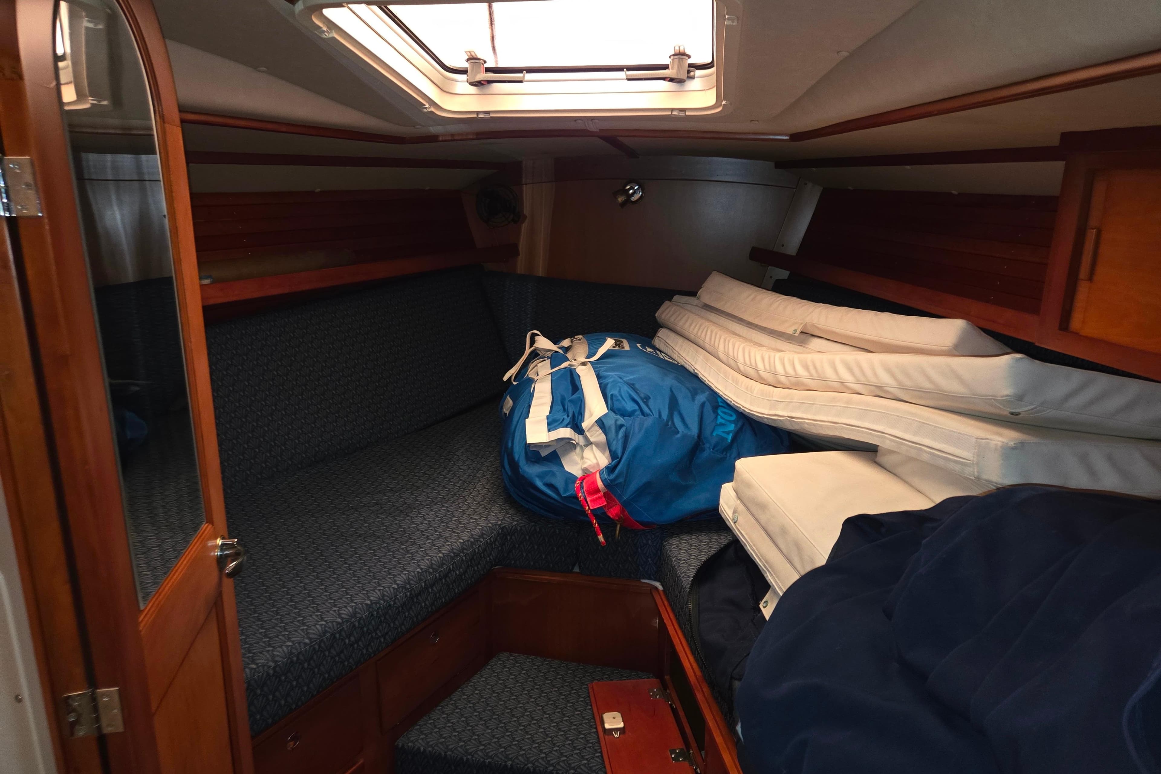 Interior cabin of 2000 J Boats J/46 sailboat with cushions and gear.