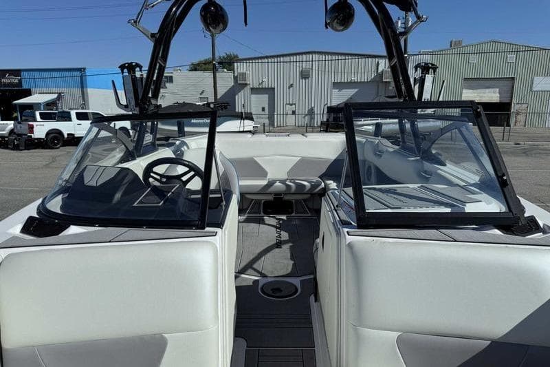 2021 Moomba Max boat interior with open windshield, white seating, and modern dashboard.
