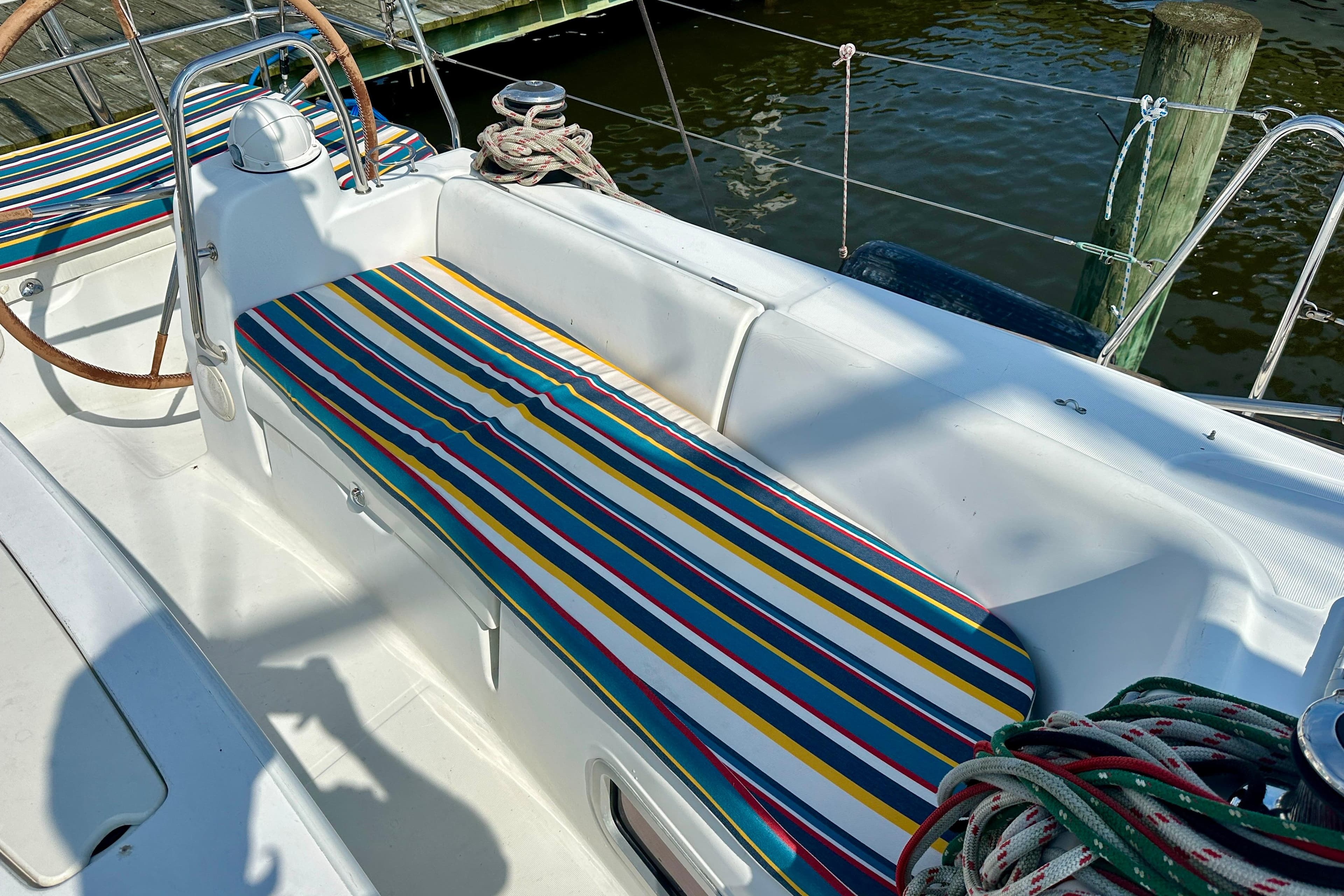 Colorful striped seating on 2010 Beneteau Oceanis 40 sailboat deck.