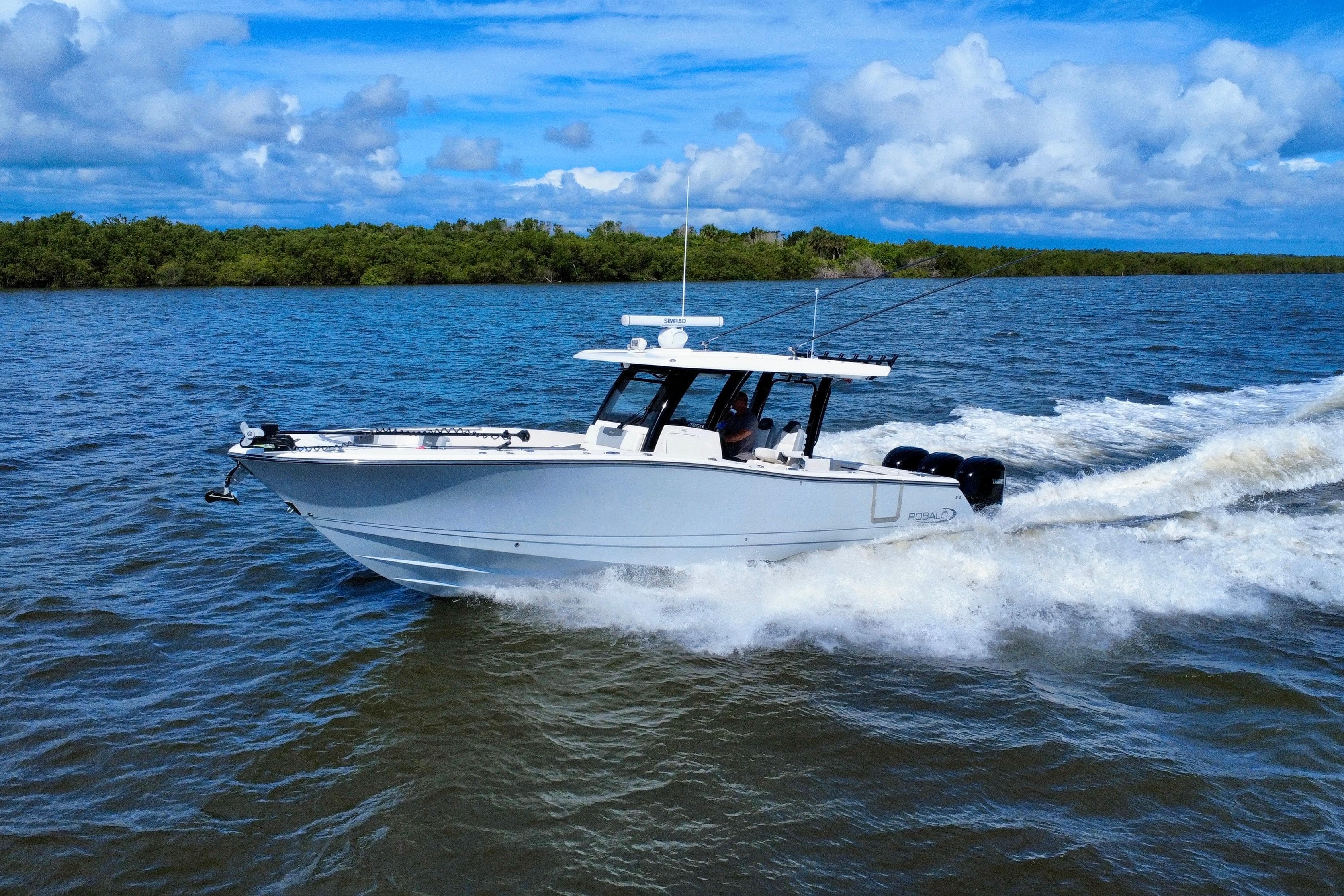 2022 Robalo R360 Center Console boat cruising on open water under blue skies.