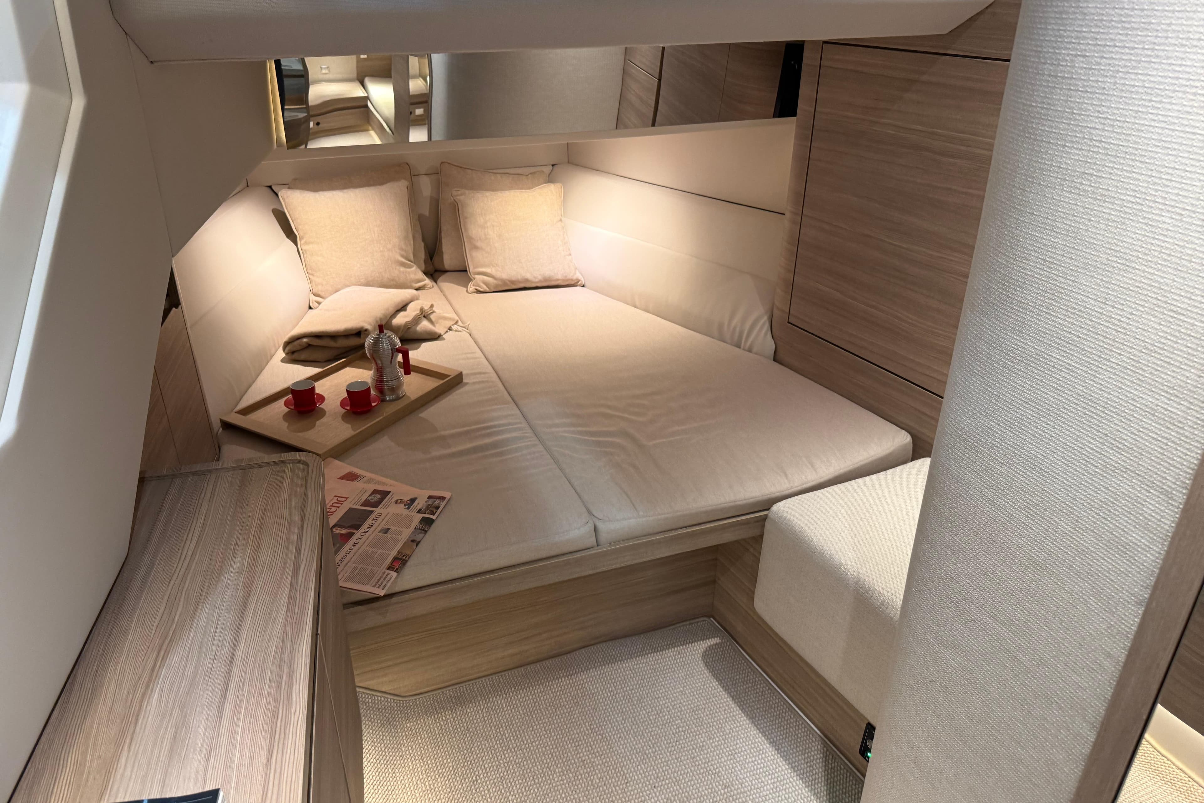 Luxurious interior cabin of 2026 Saxdor 460 GTC yacht with cozy bedding and modern decor.