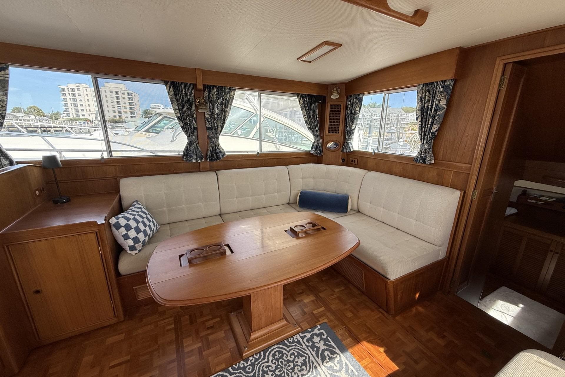 1999 Grand Banks 42 Classic yacht interior with elegant wood finish and cozy seating area.