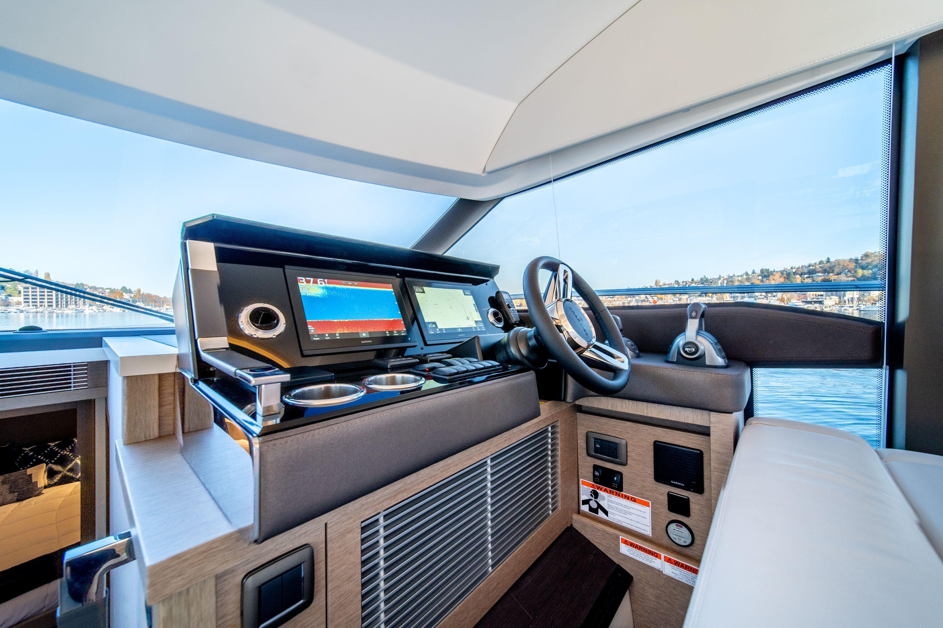 Modern helm station of 2026 Prestige 520 yacht with advanced navigation systems.