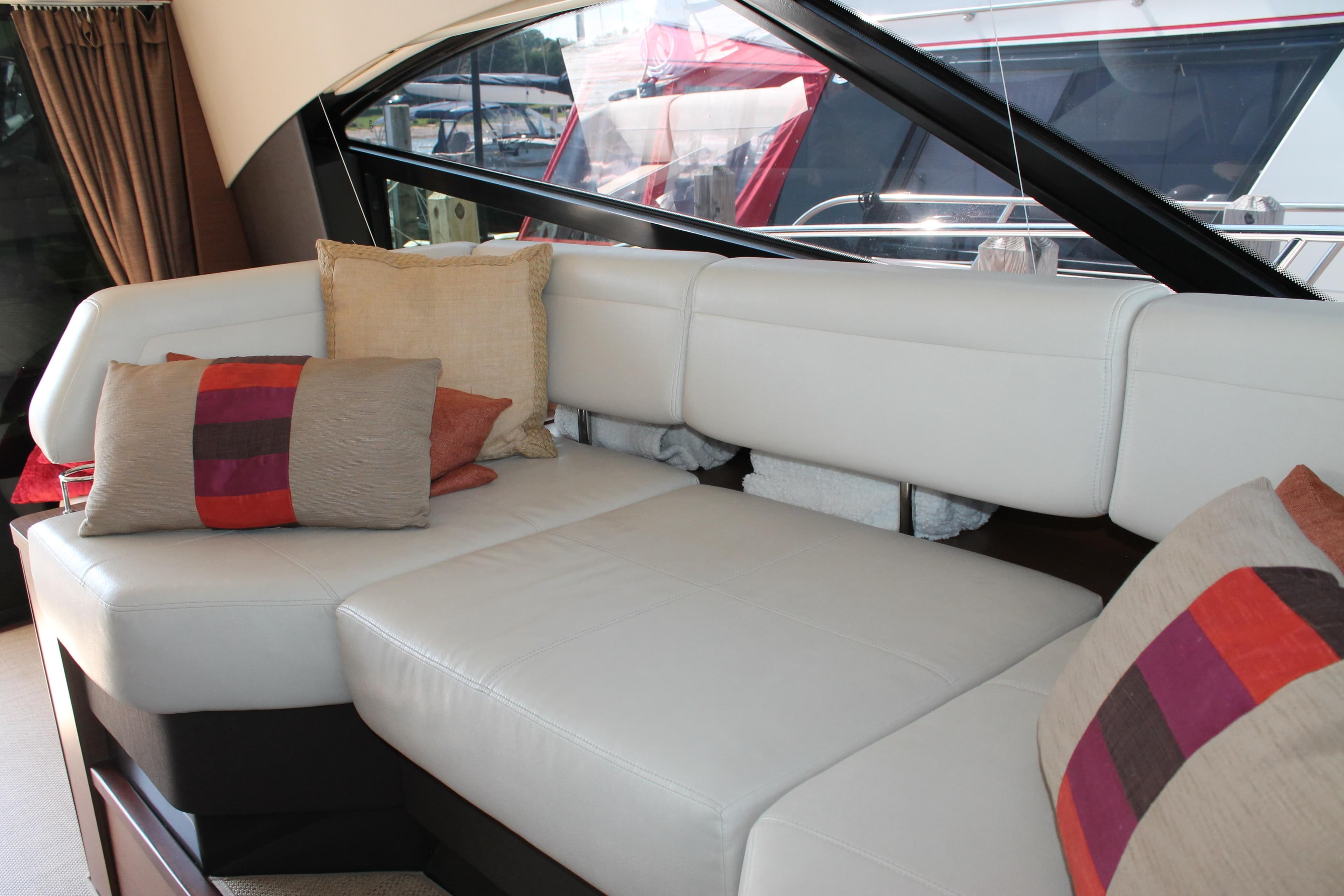 Luxurious interior seating on 2015 Sea Ray 470 Sundancer yacht with stylish cushions.