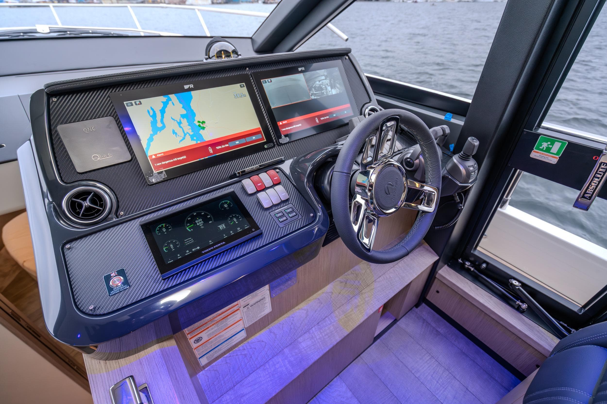 Helm of 2026 Absolute 48 Coupe yacht with advanced navigation displays and steering wheel.