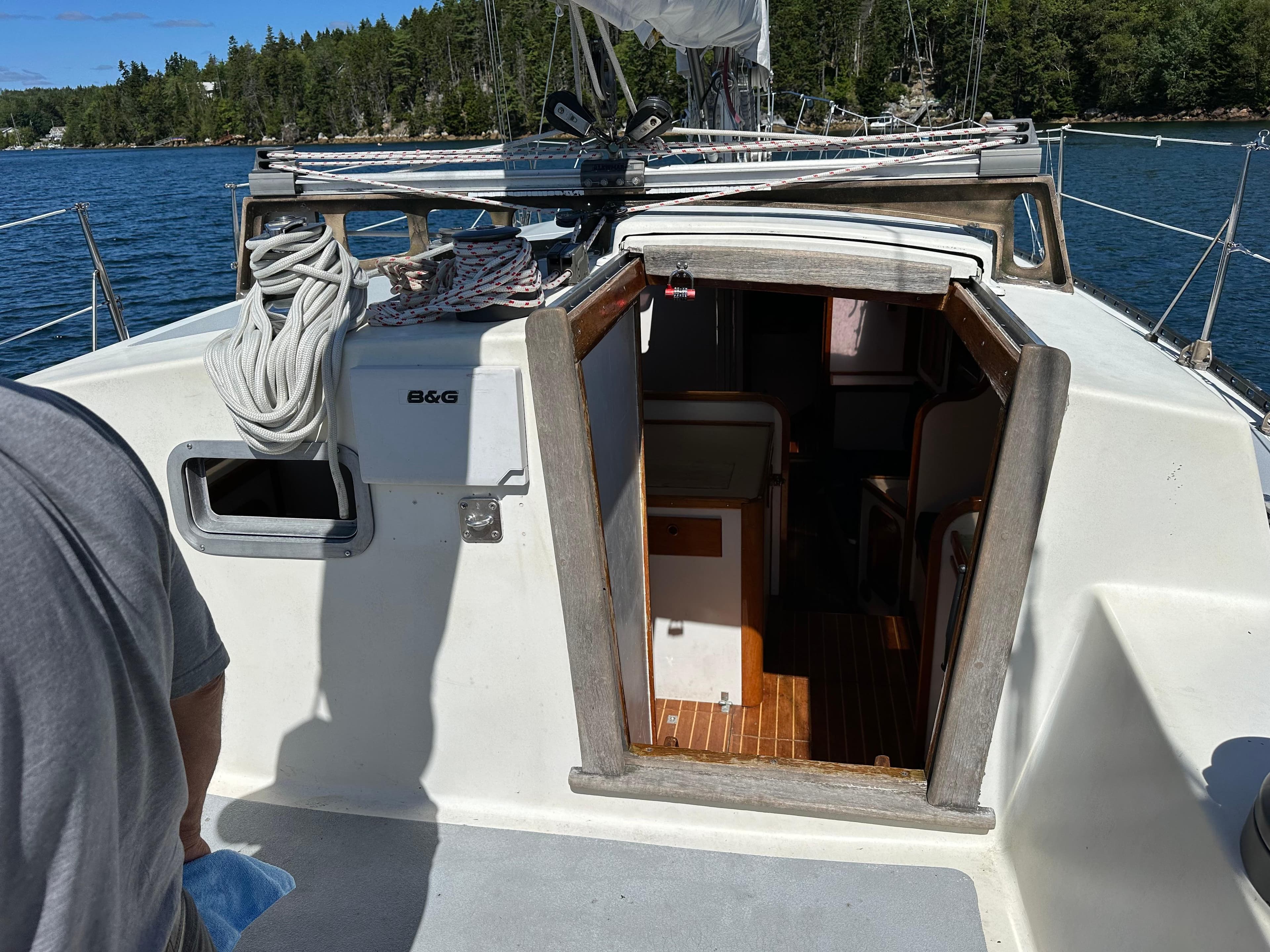 Sailboat deck view, Cartwright 44, 1985 model, with open cabin entrance.