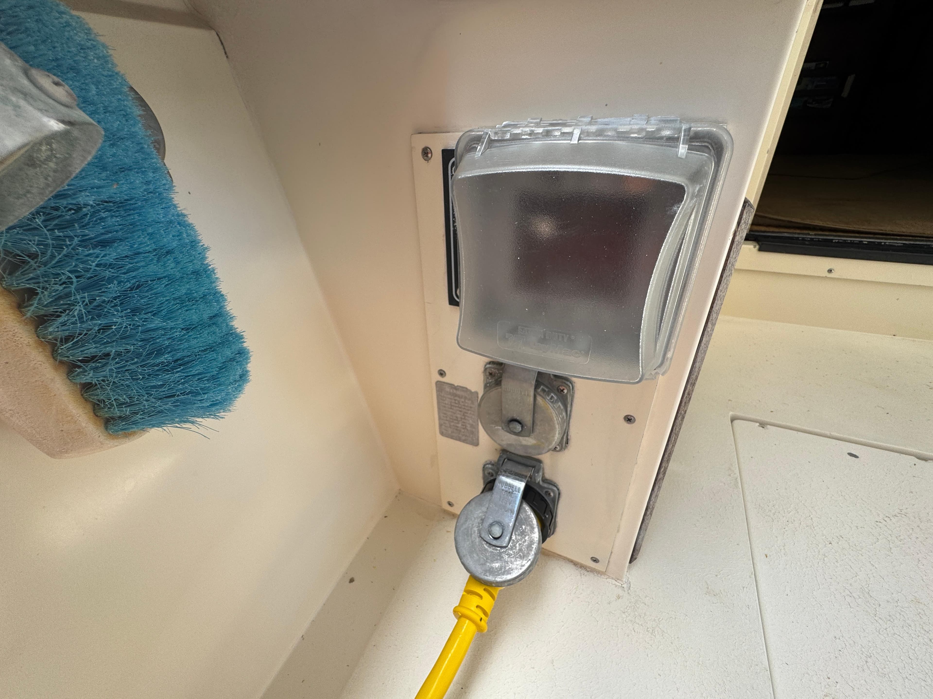 Electrical outlet with yellow cable on a 1990 Viking 35 boat.