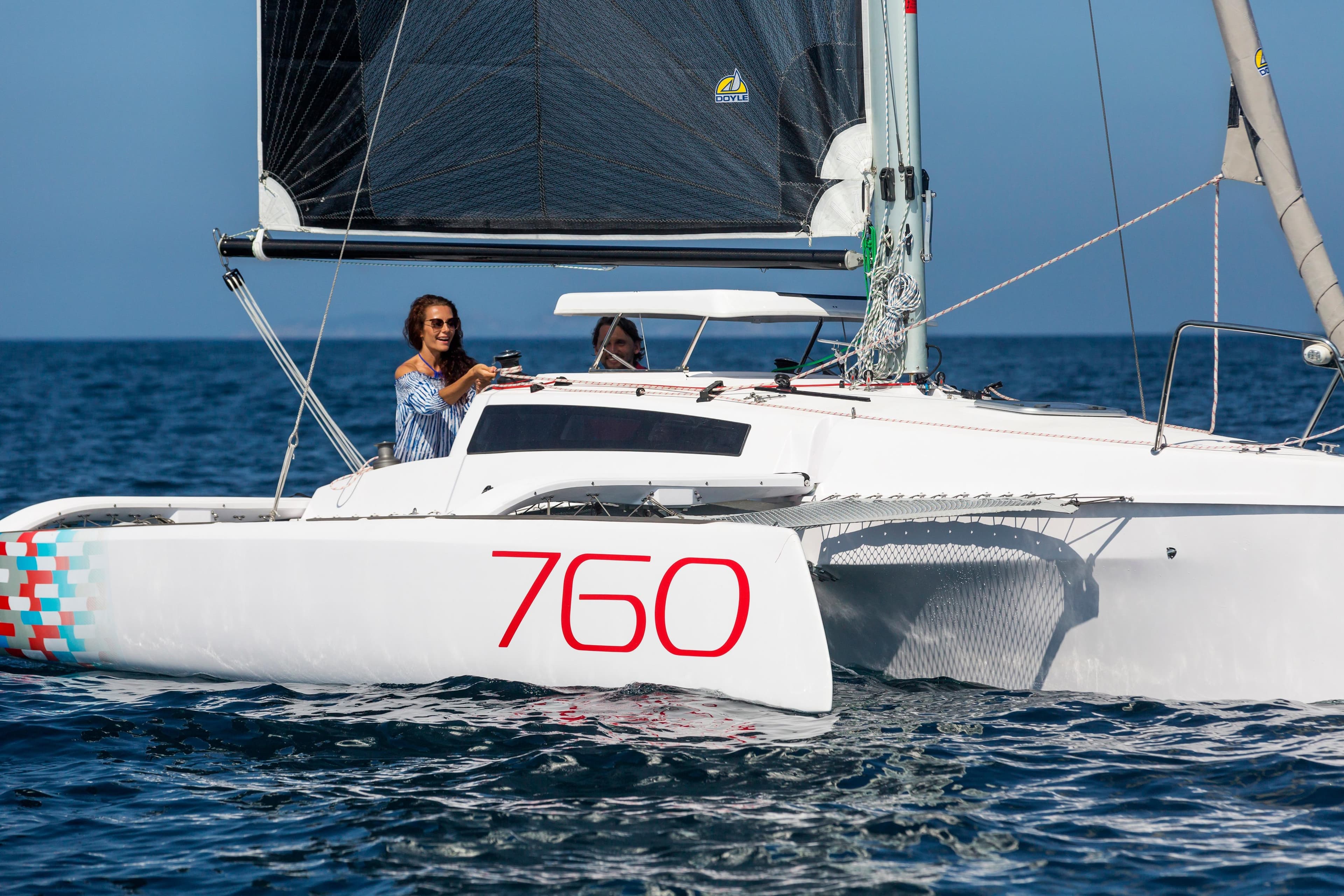 Sleek 2026 Corsair 760 sailboat on open water, featuring modern design and vibrant graphics.
