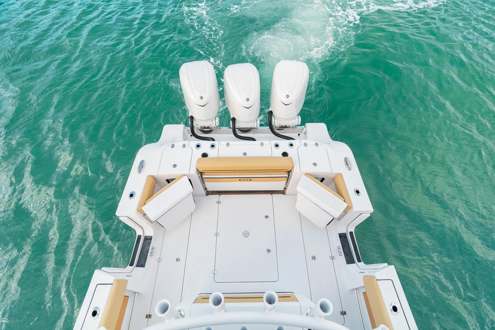 2026 Sportsman Open 352 Center Console boat on turquoise water, featuring triple engines.