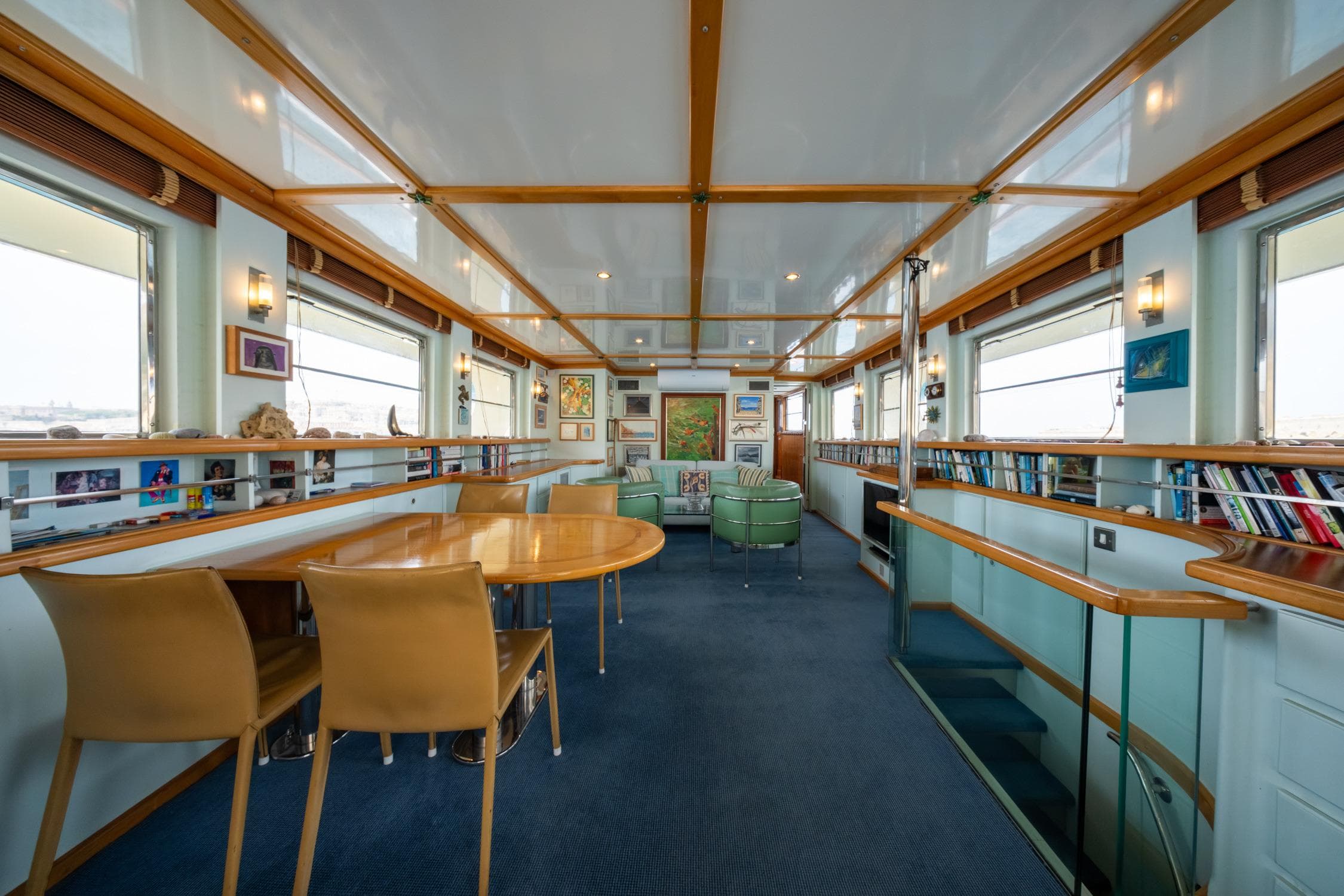 Luxurious 1972 Custom Siccna yacht interior with elegant dining area and panoramic windows.