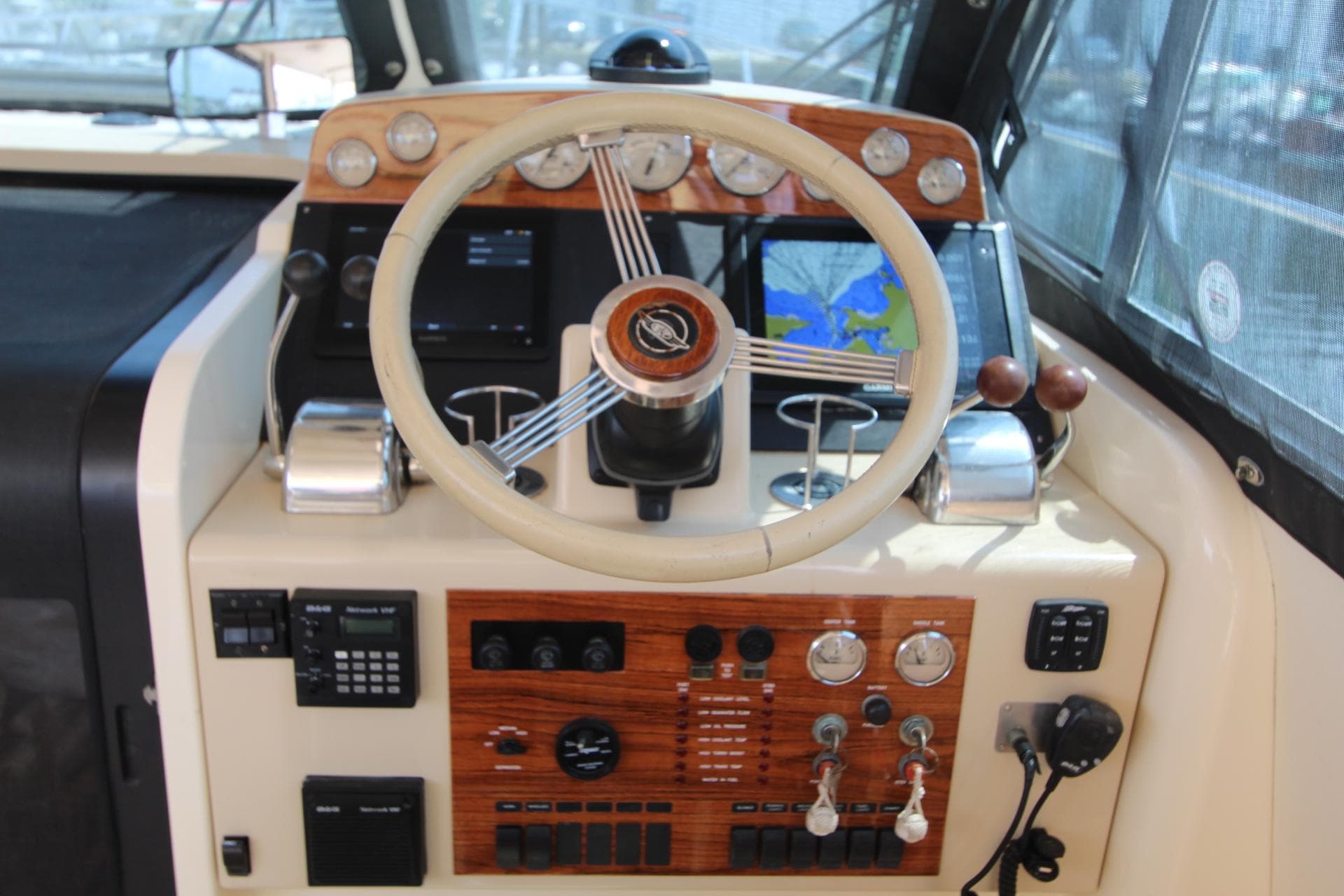 Island Packet 360 yacht helm, 2002 model, featuring wood paneling and navigation system.