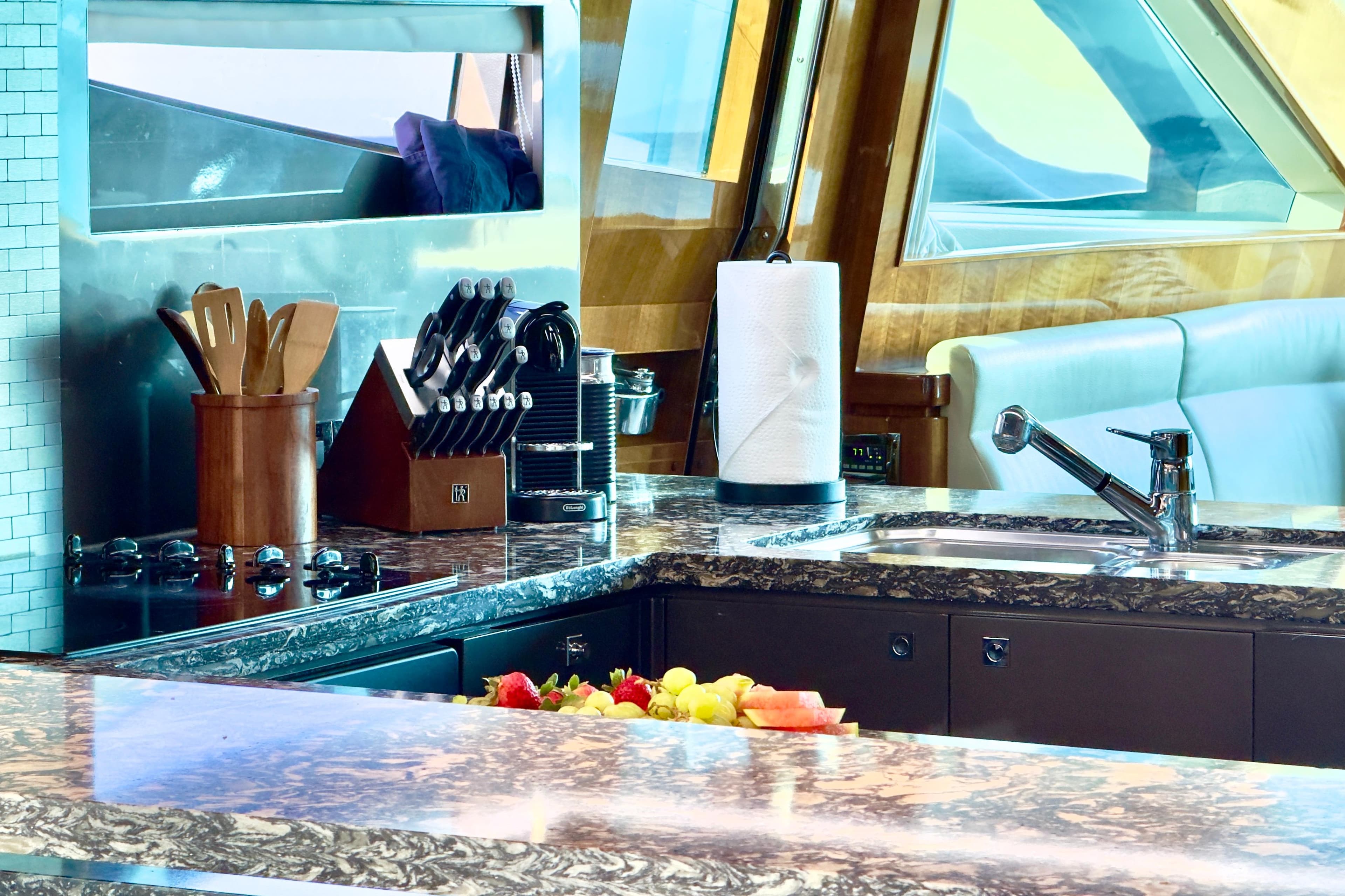Luxurious yacht kitchen interior with granite countertops, knife set, and modern appliances on Horizon E88, 2011.