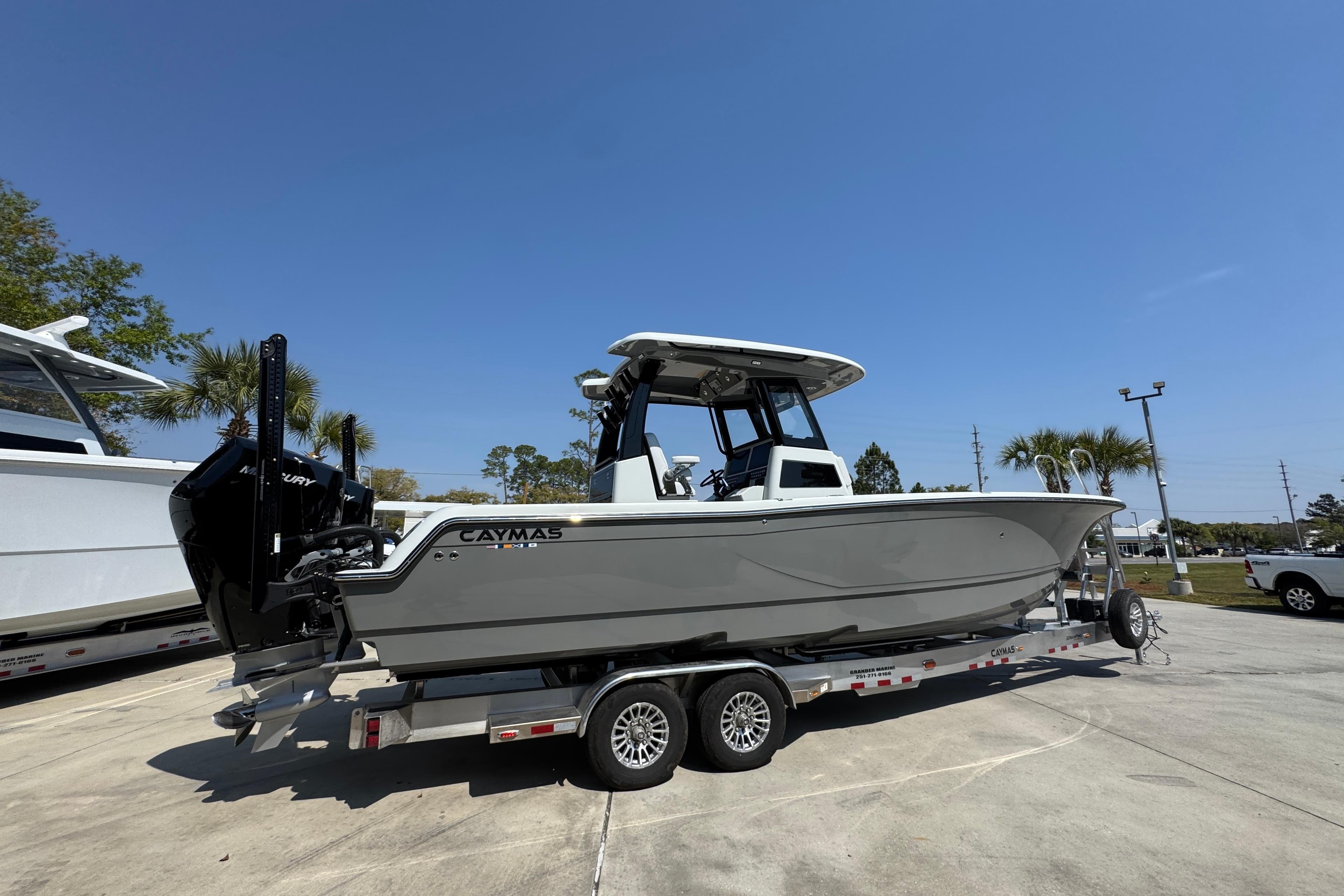 2026 Caymas 29 CT boat on trailer under clear blue sky.