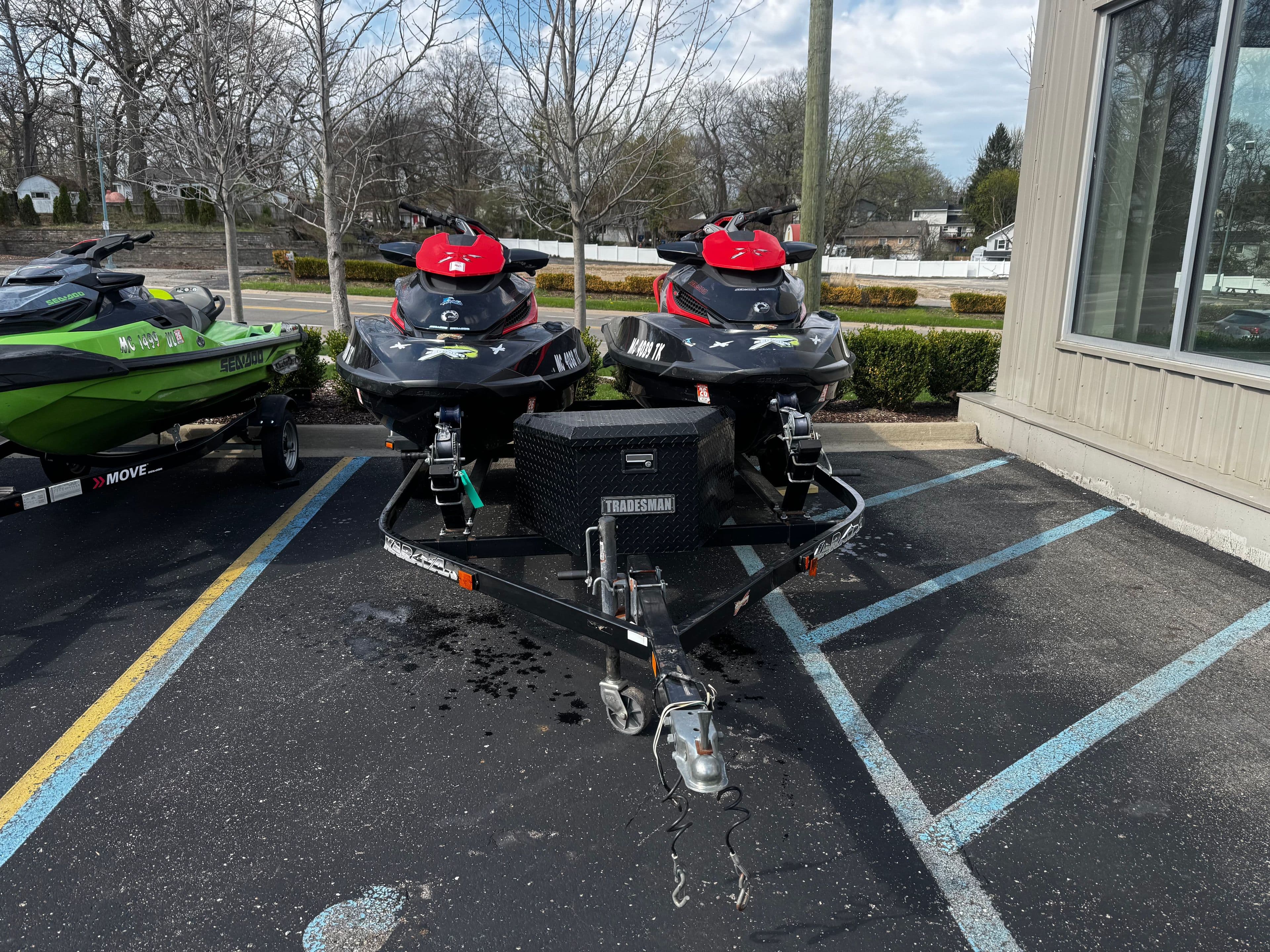 Two 2011 Sea-Doo RXT 260 jet skis parked on a trailer outdoors.