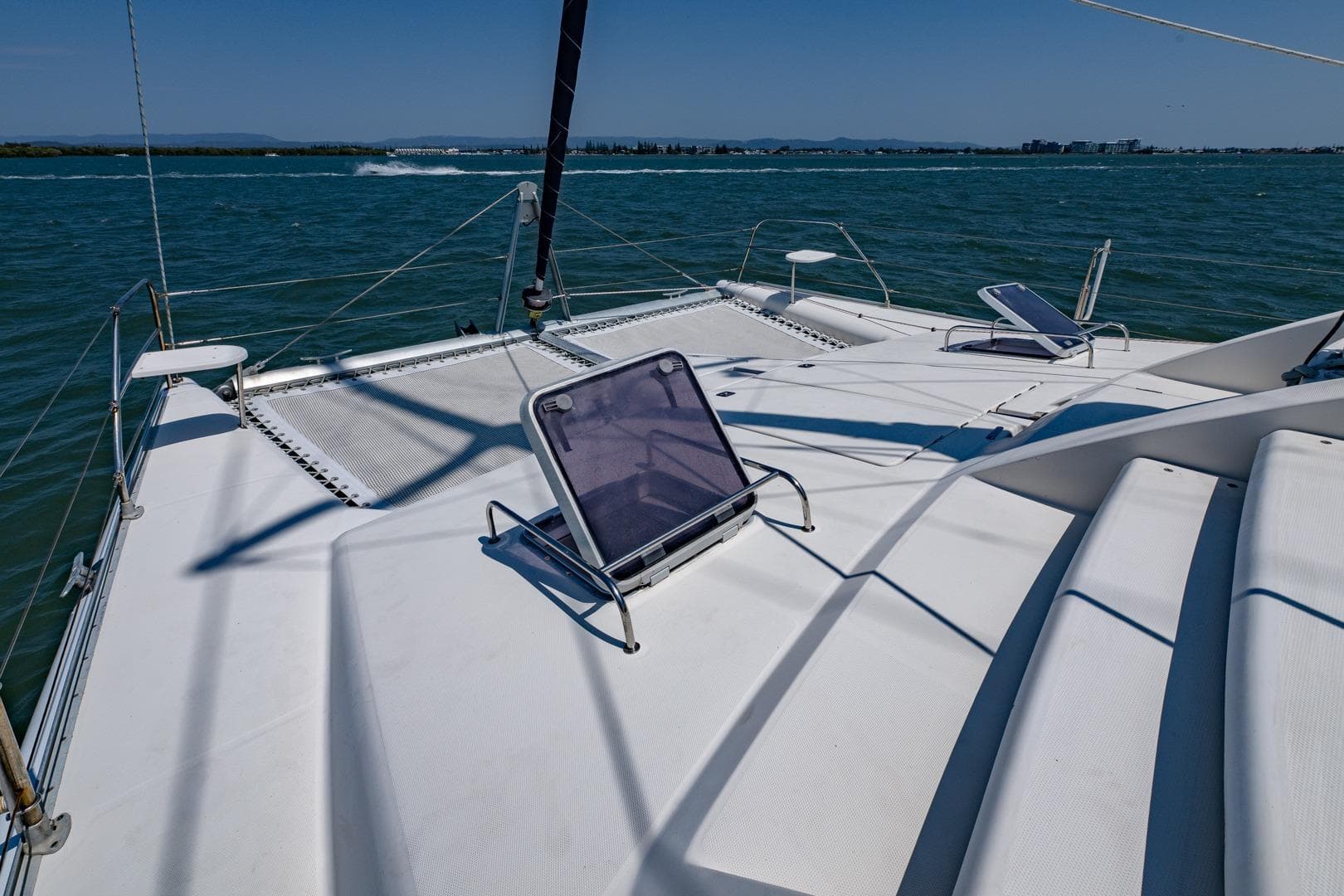 Deck of 2000 Leopard 38 catamaran with sun loungers on a sunny day.